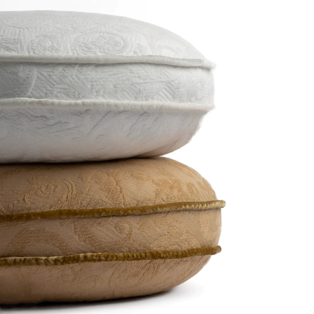 : Two 18 inch diameter throw pillows stacked against a white background. Pillows shown in Winter White and Honeycomb.