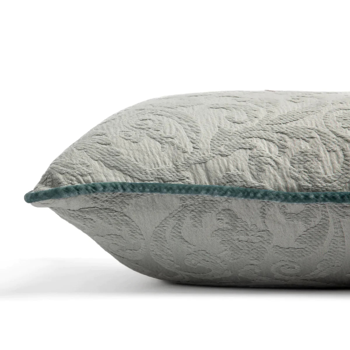 Eucalyptus: Organic cotton damask square pillow with silk velvet trim on white background — side angle.