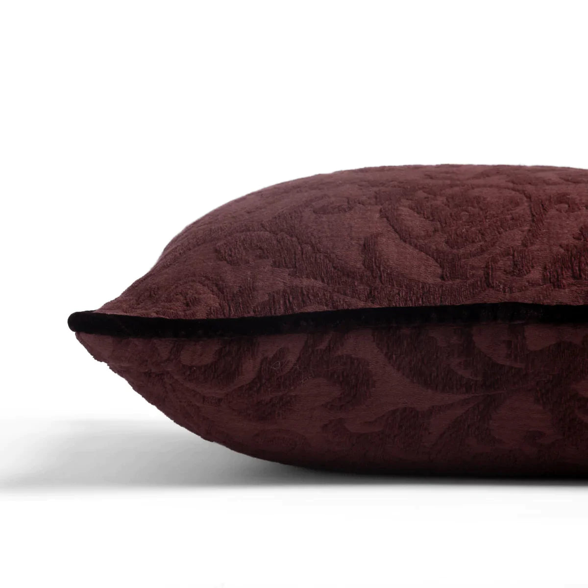 Mahogany: Organic cotton damask square pillow with silk velvet trim on white background — side angle.