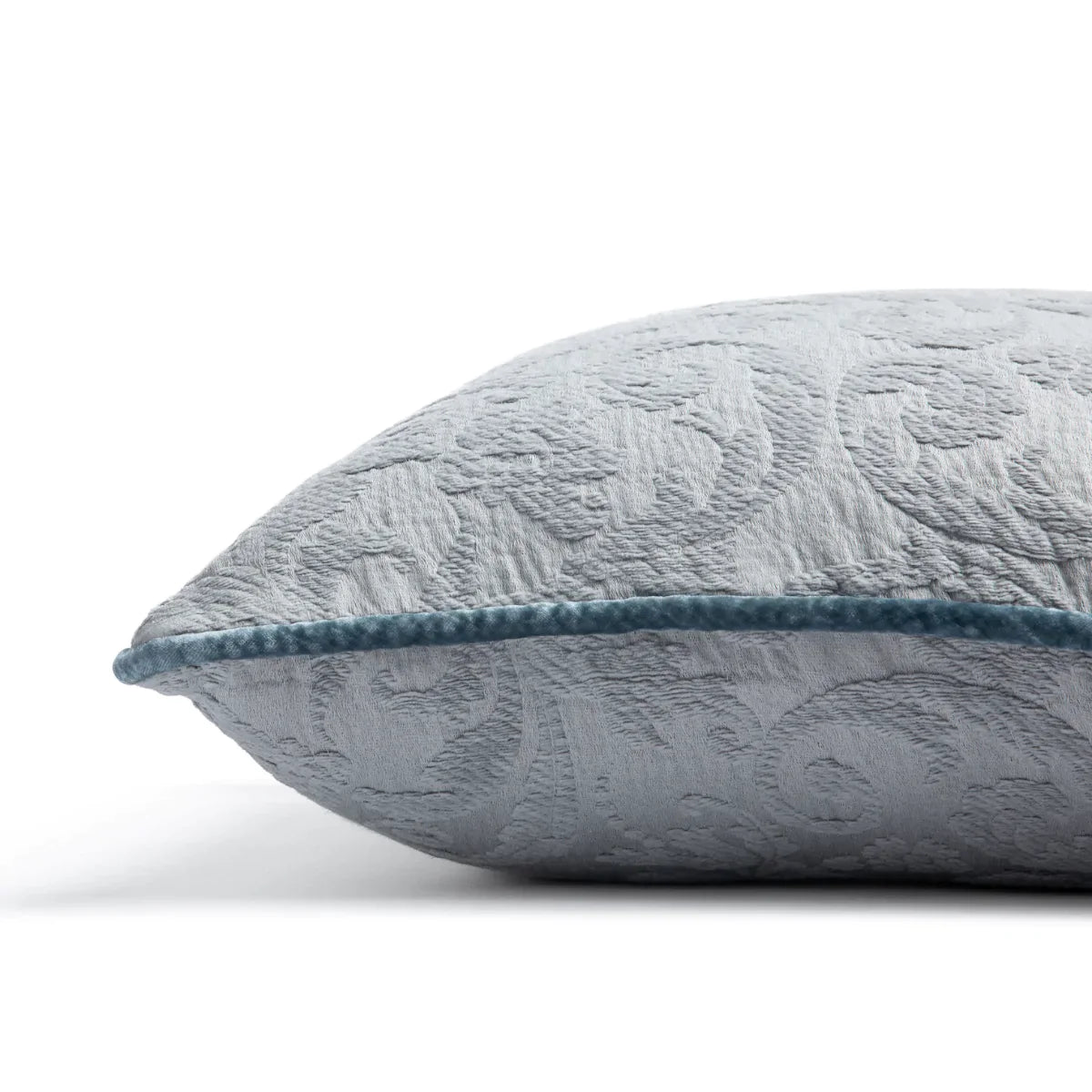 Mineral: Organic cotton damask square pillow with silk velvet trim on white background — side angle.