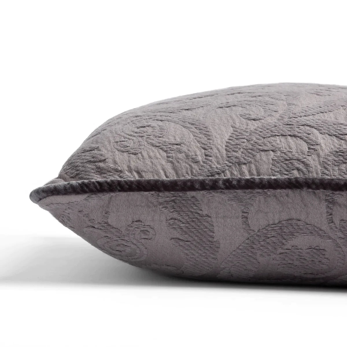 Moonlight: Organic cotton damask square pillow with silk velvet trim on white background — side angle.