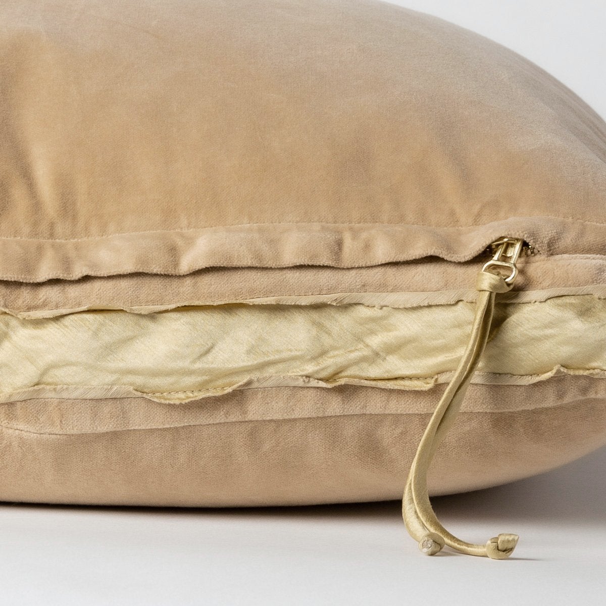 Honeycomb: Close-up of charmeuse gusset, raw-edge trim, and brass zipper detail on cotton velvet sham - side view.