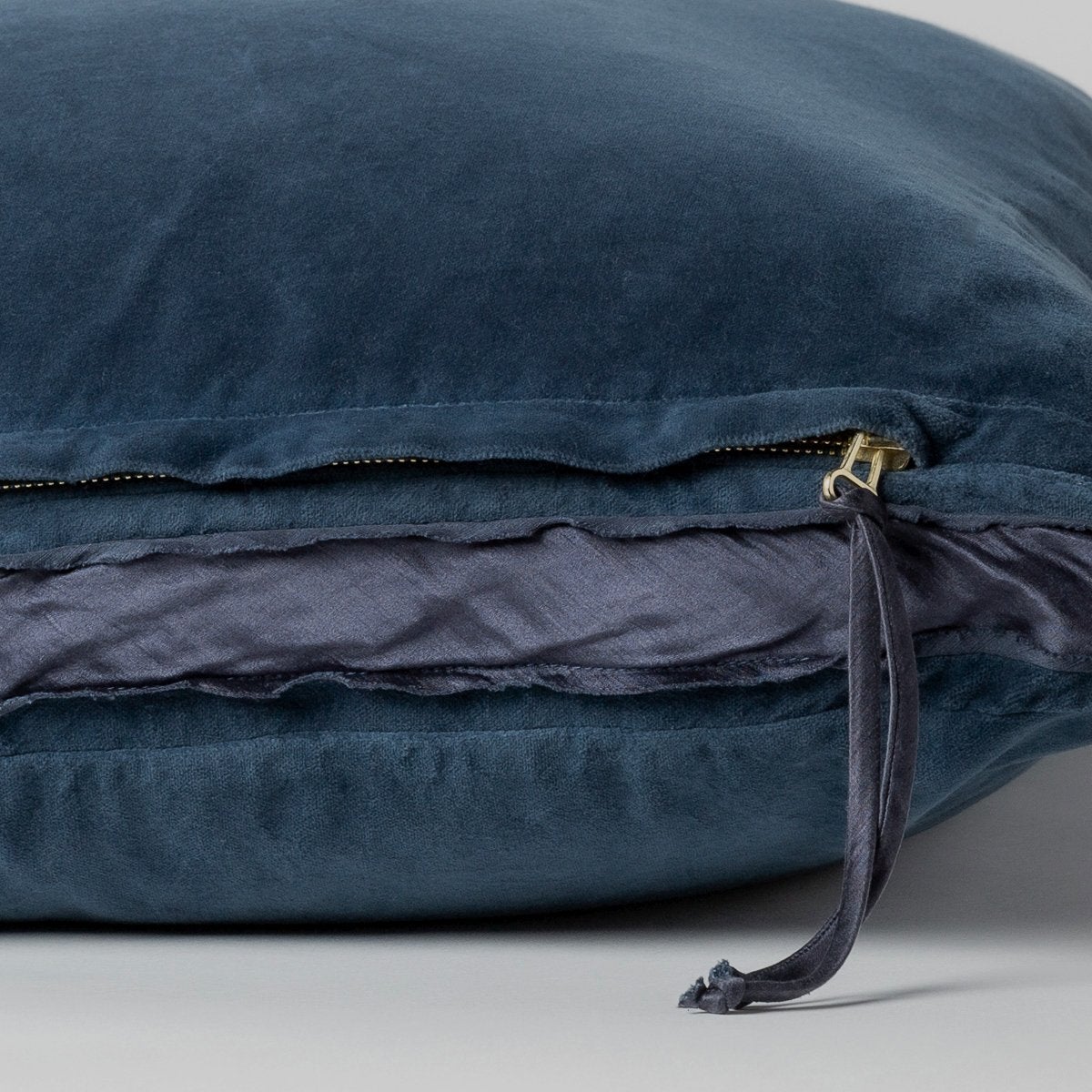 Midnight: Close-up of charmeuse gusset, raw-edge trim, and brass zipper detail on cotton velvet sham - side view.