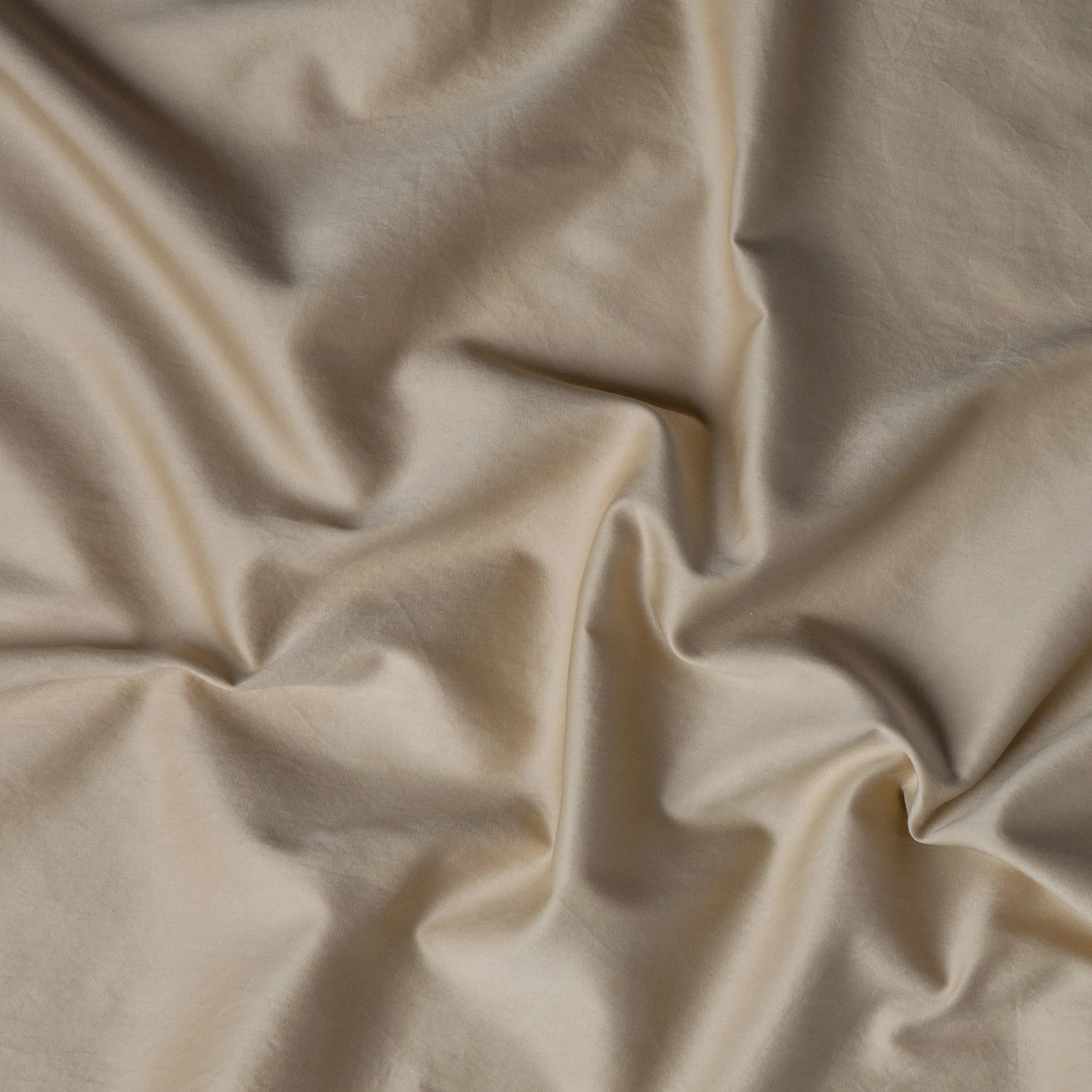 Honeycomb: A close up of cotton sateen fabric in honeycomb, a warm golden tone.