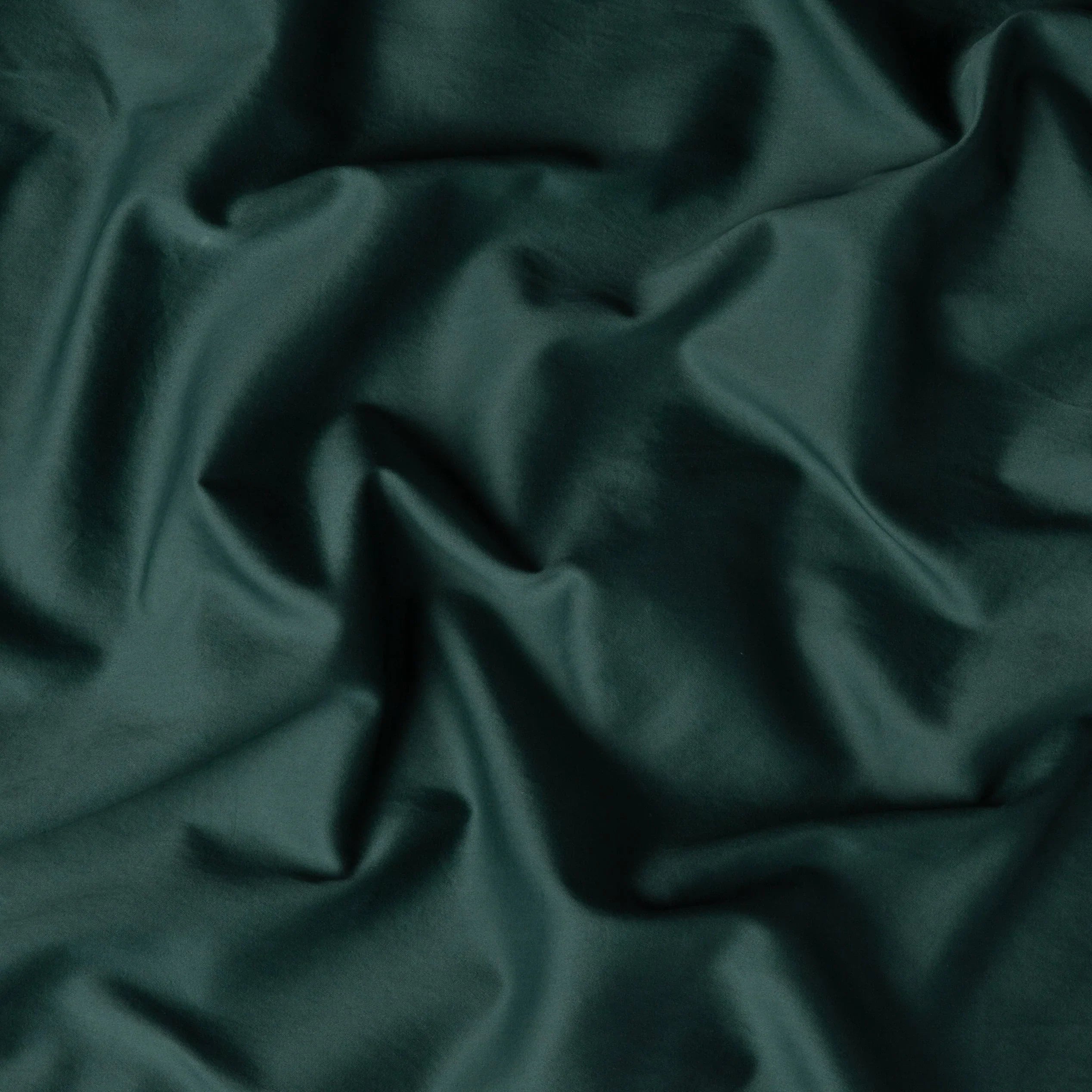 Jade: A close up of cotton sateen fabric in jade, a rich, verdant green with subtle blue undertones.