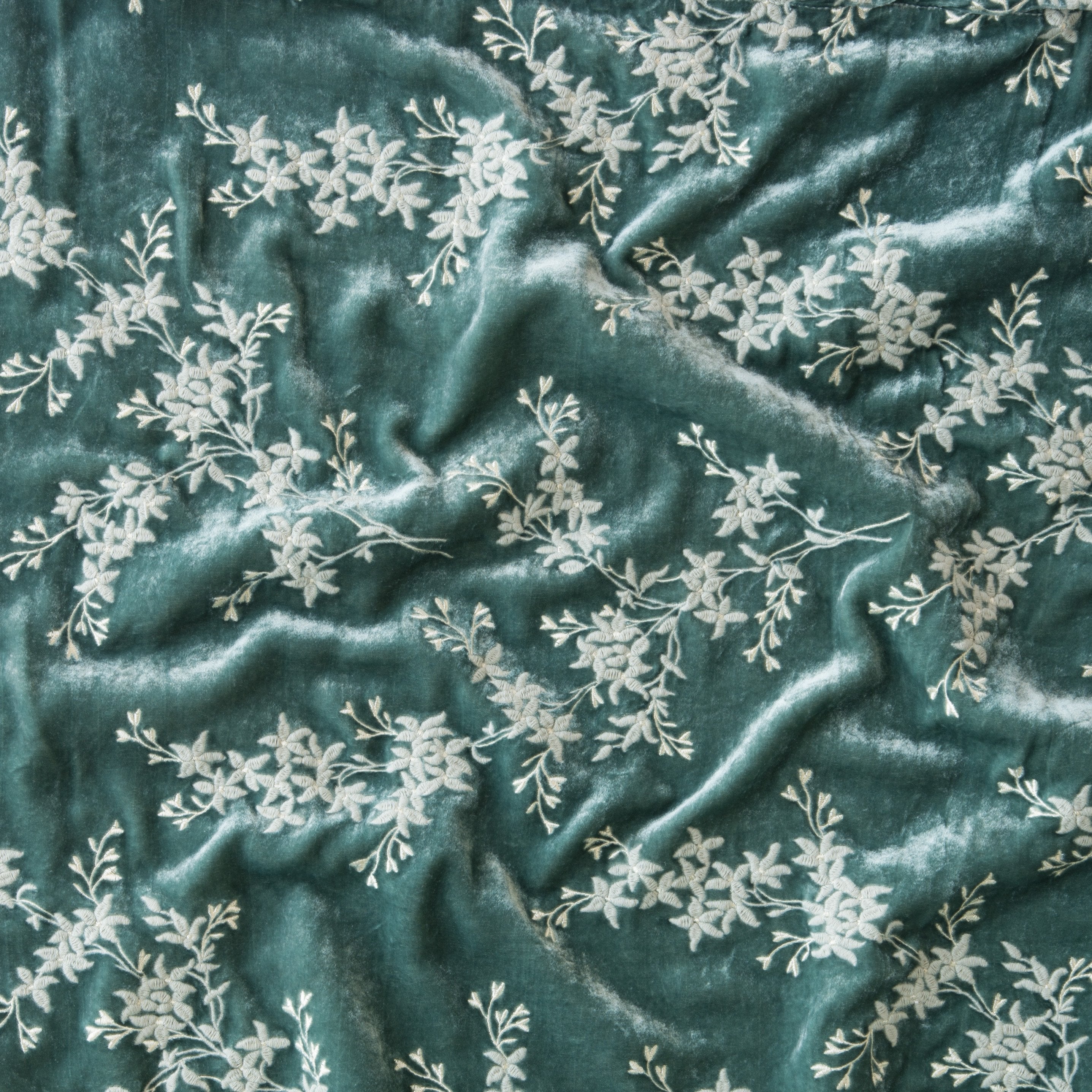 Eucalyptus: A close up of Lynette embroidered silk velvet, in eucalyptus, a soft light green.