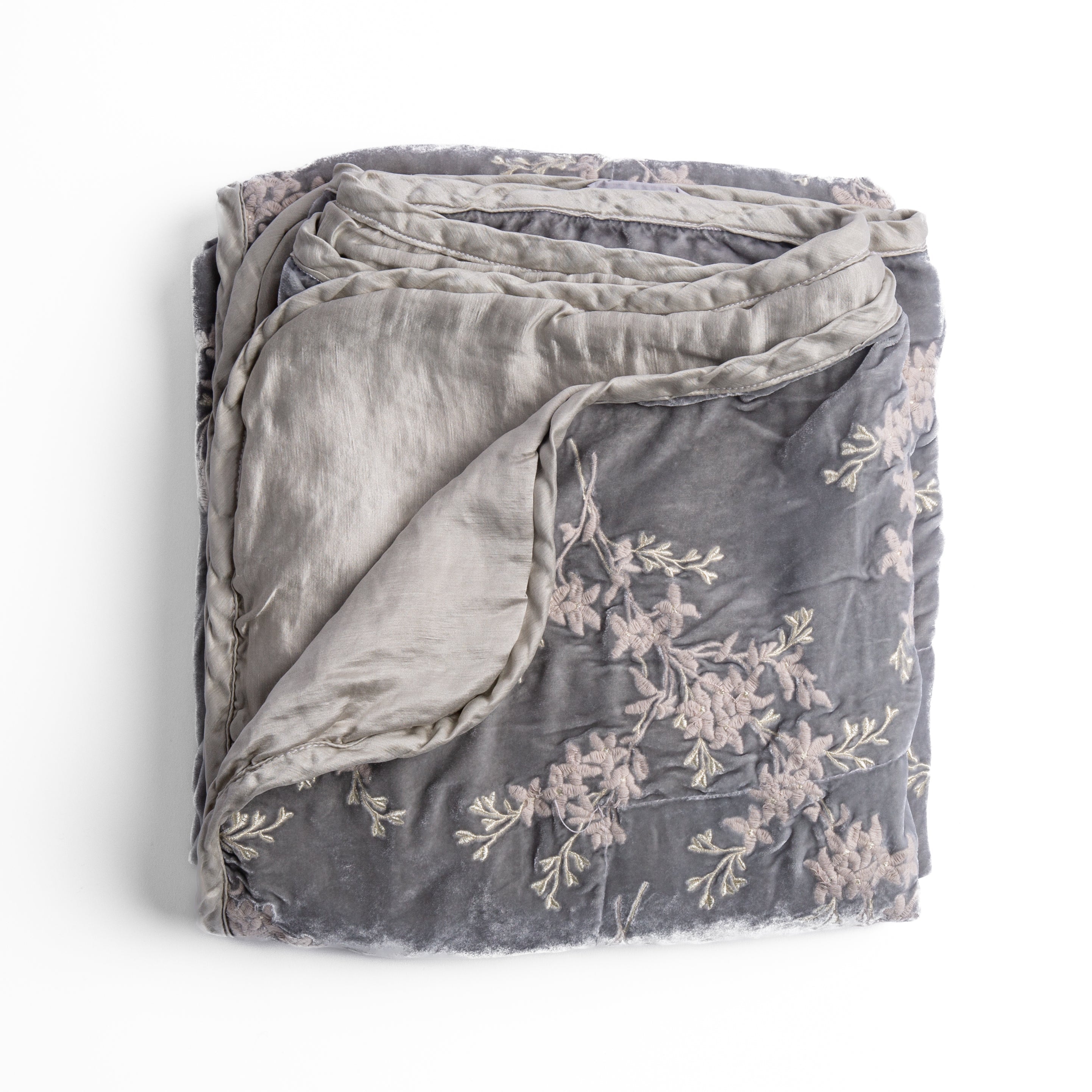 Sterling: overhead angle of the folded blanket with a corner pulled back to show the reverse and trim.