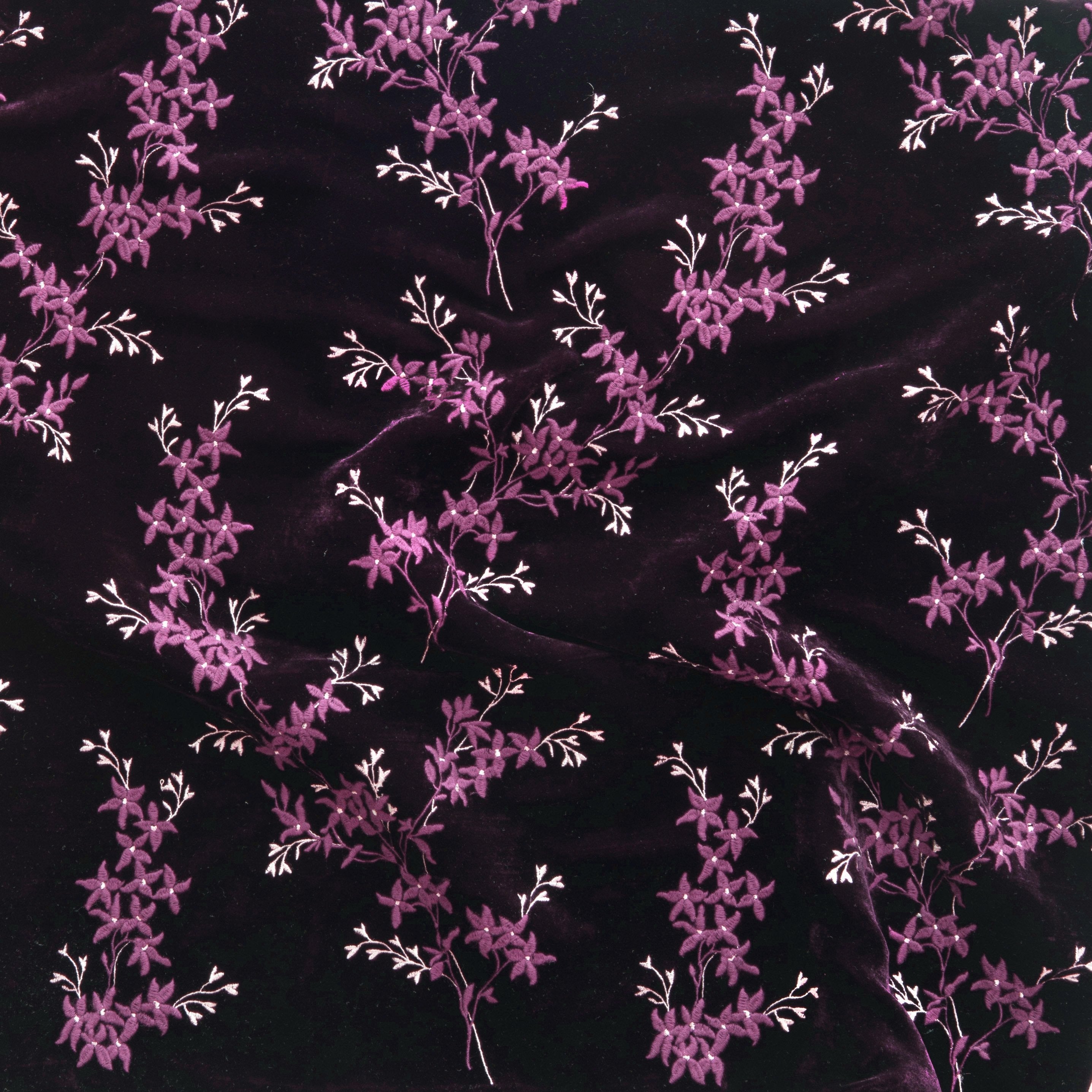 Fig: A close up of Lynette embroidered silk velvet, in fig, a richly saturated purple-garnet.