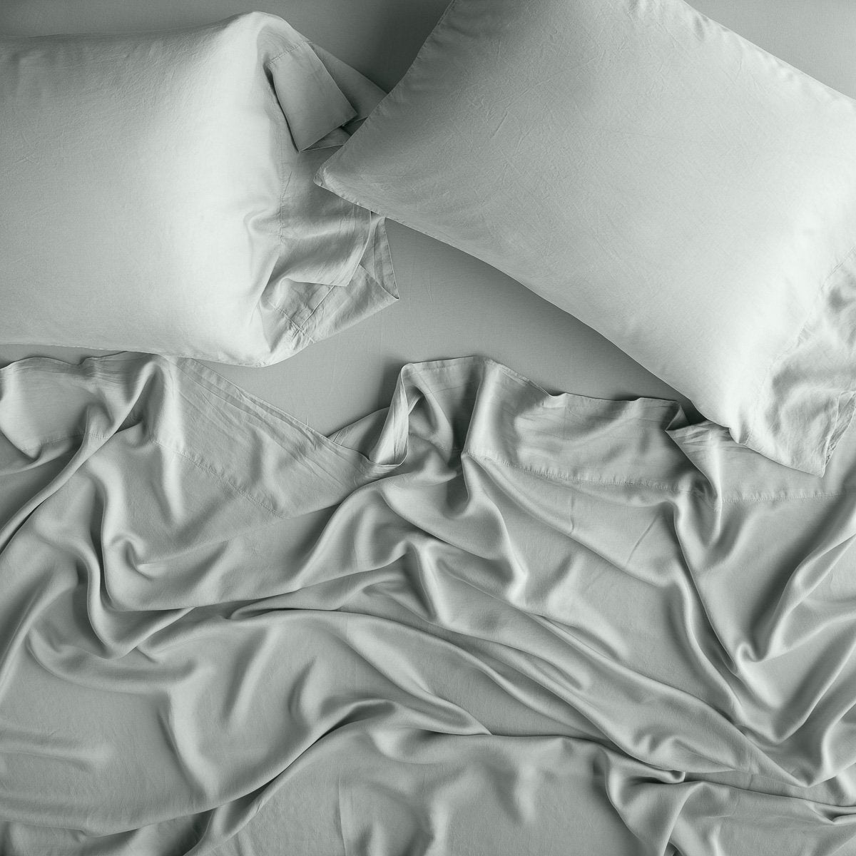 Eucalyptus: Rumpled sheeting, shown with matching sleeping pillows - overhead view.