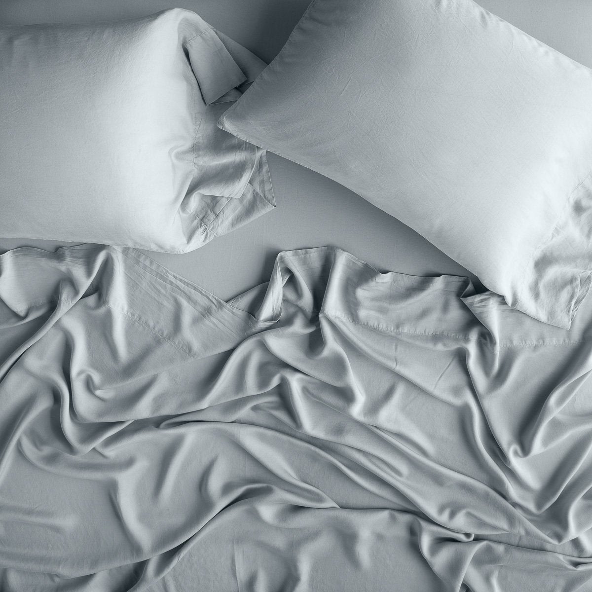 Mineral: Rumpled sheeting, shown with matching sleeping pillows - overhead view.
