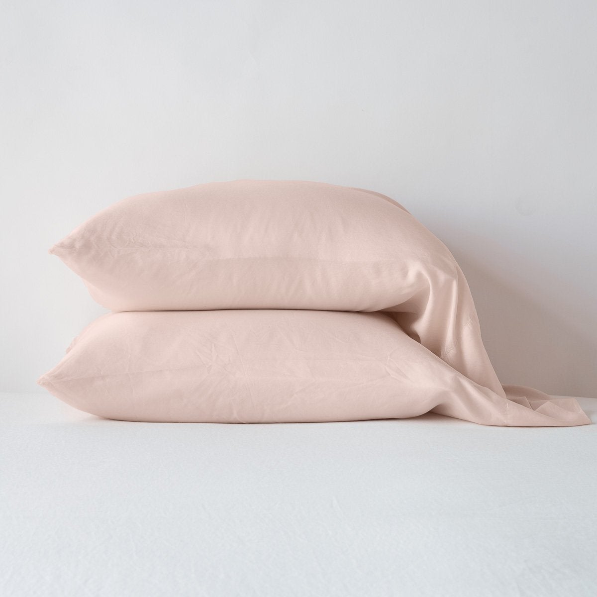 Rouge: sleeping pillows stacked neatly against a white backdrop - side view.