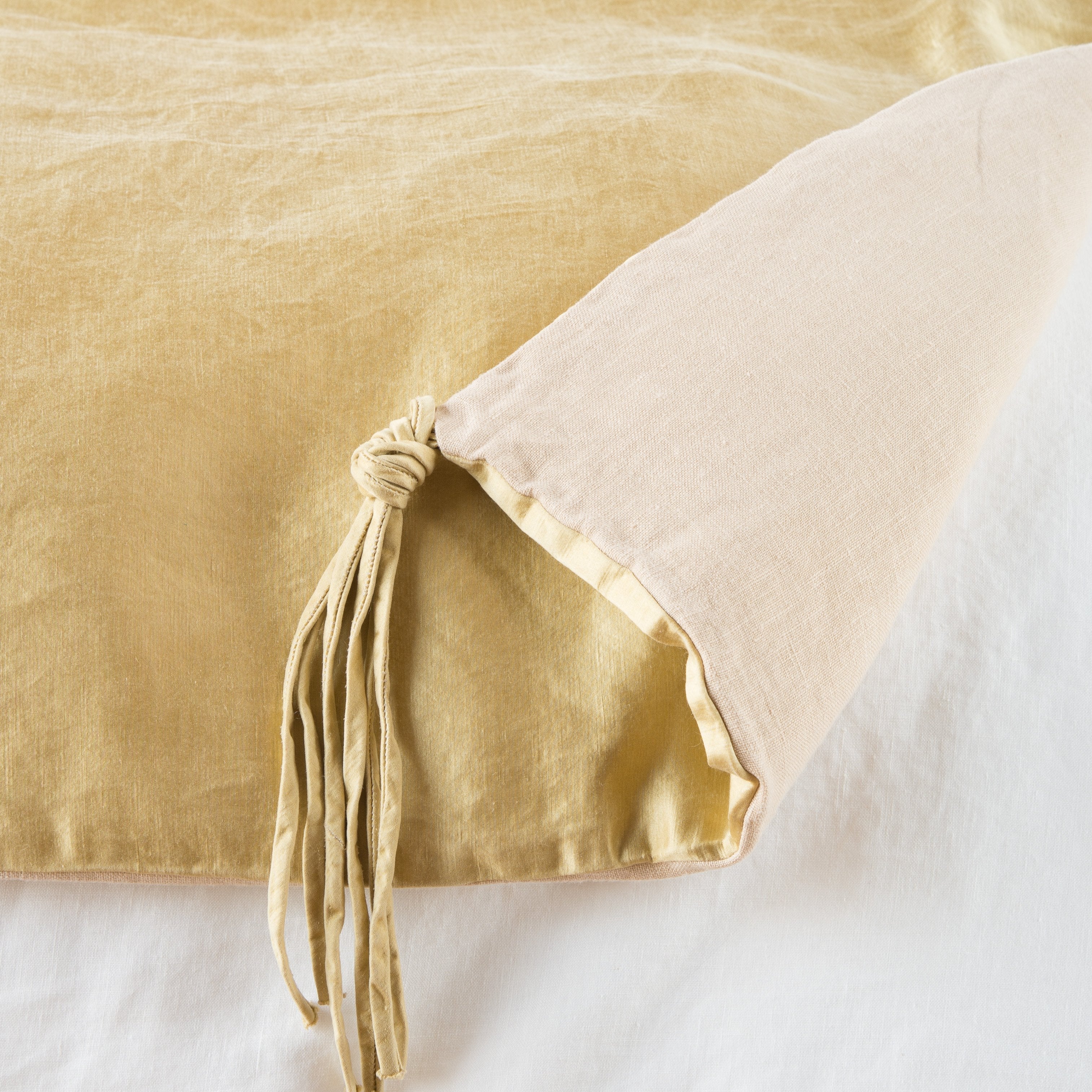 Honeycomb: Close up of blanket, with a corner turned back to showcase the midweight linen back and corner tassel - overhead view.