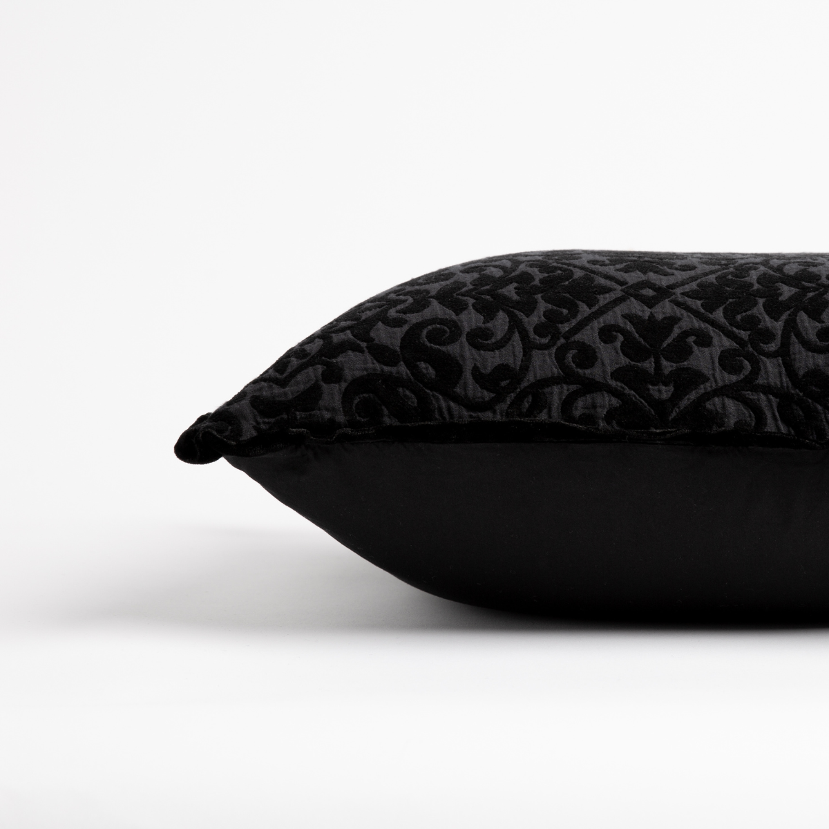 Corvino: side view of 18x18 pillow shows cotton sateen back and silk velvet trim detail — close up against a white background.