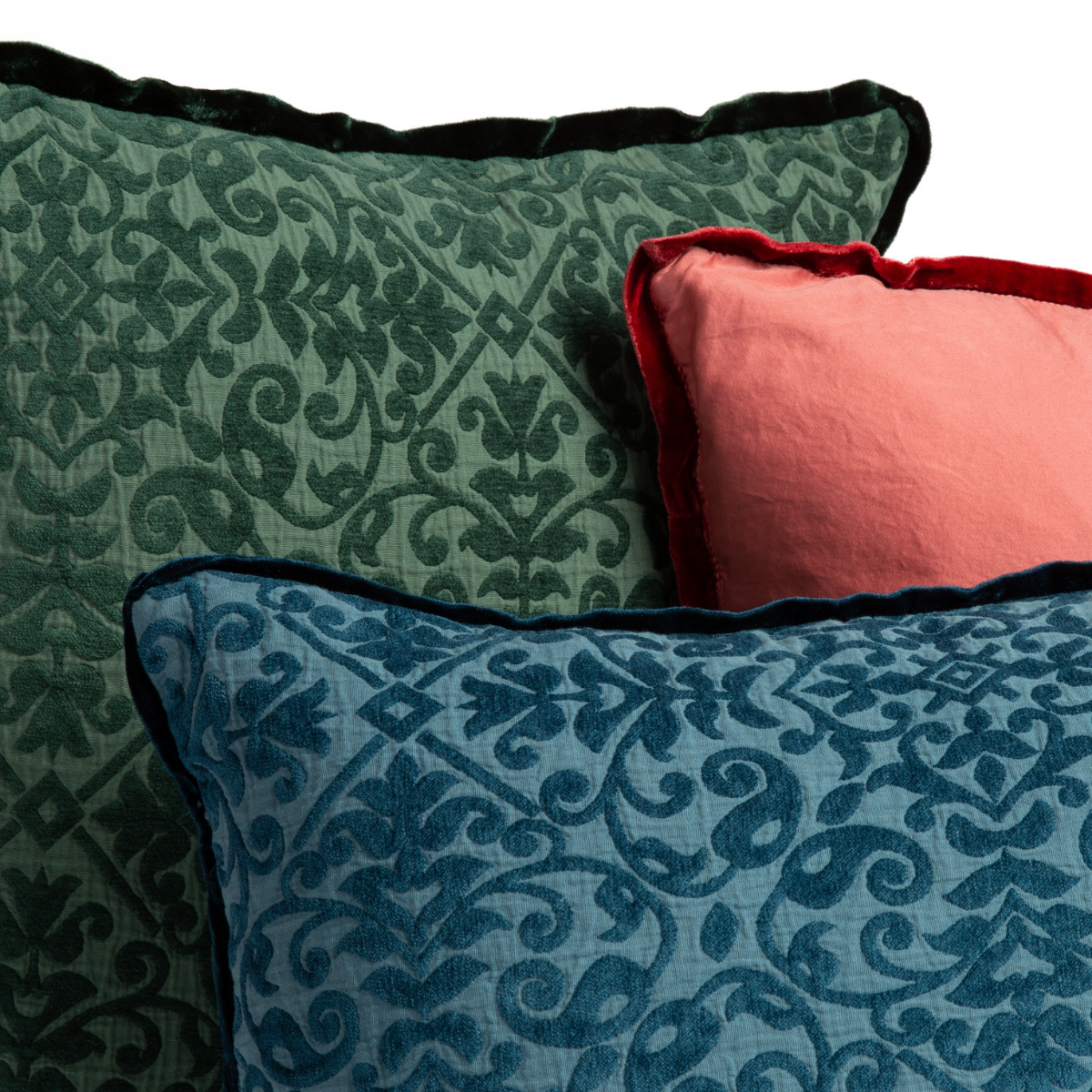 : corner detail of three pillows shows the silk velvet flat piping against both the patterned cotton chenille jacquard and plain cotton sateen.