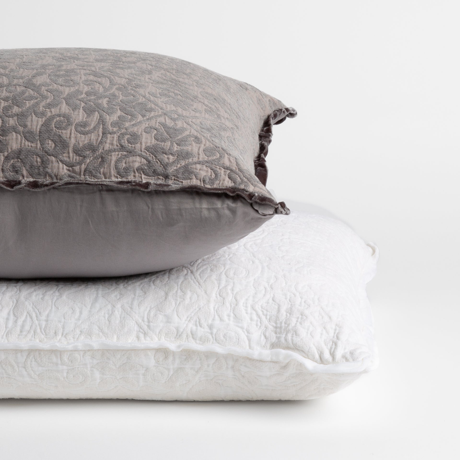 : two chenile jacquard pillows stacked to show different in their backing — straight on against a white background.