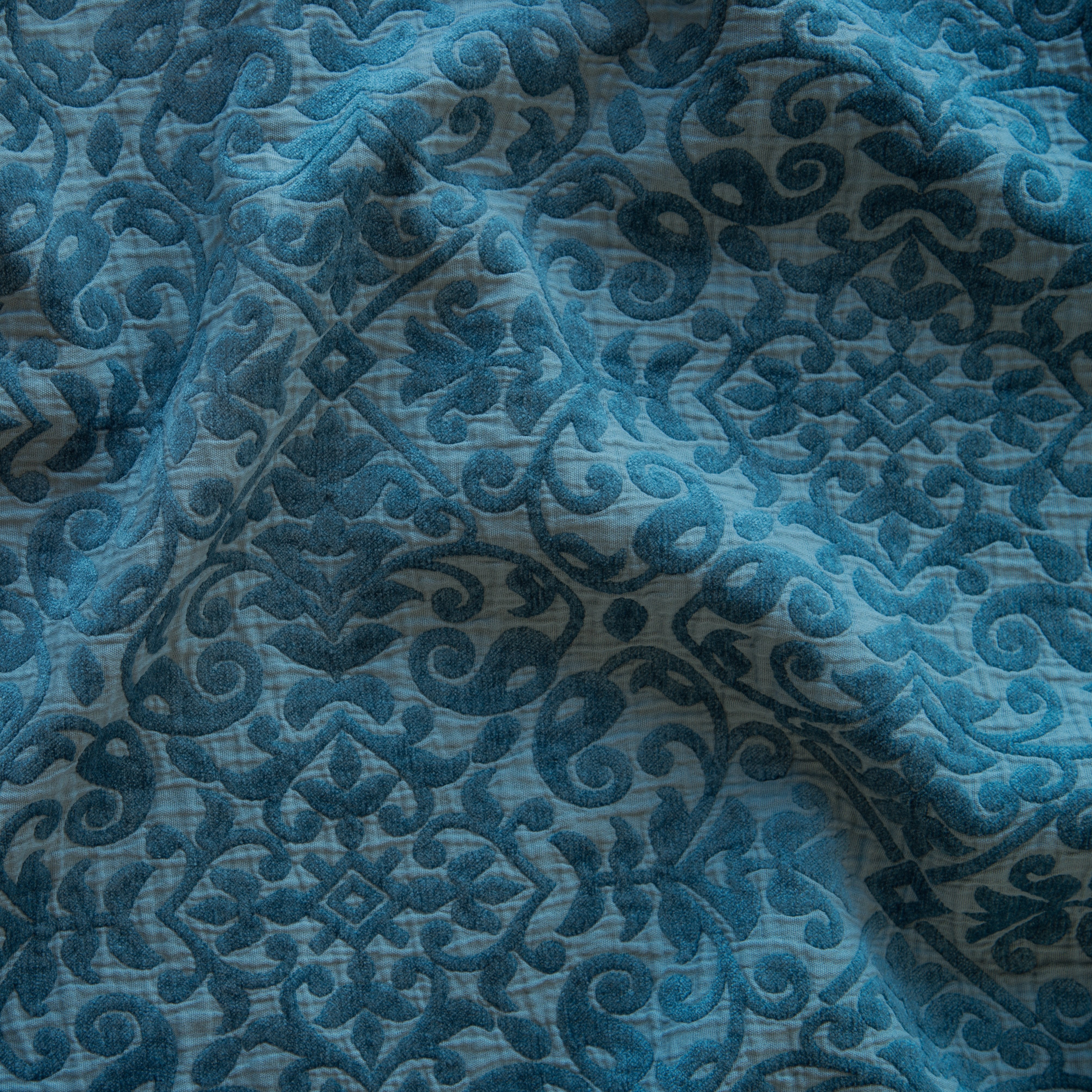 Cenote: A close up of Vienna cotton chenille jacquard in cenote, a vibrant, ocean-inspired blue-green.