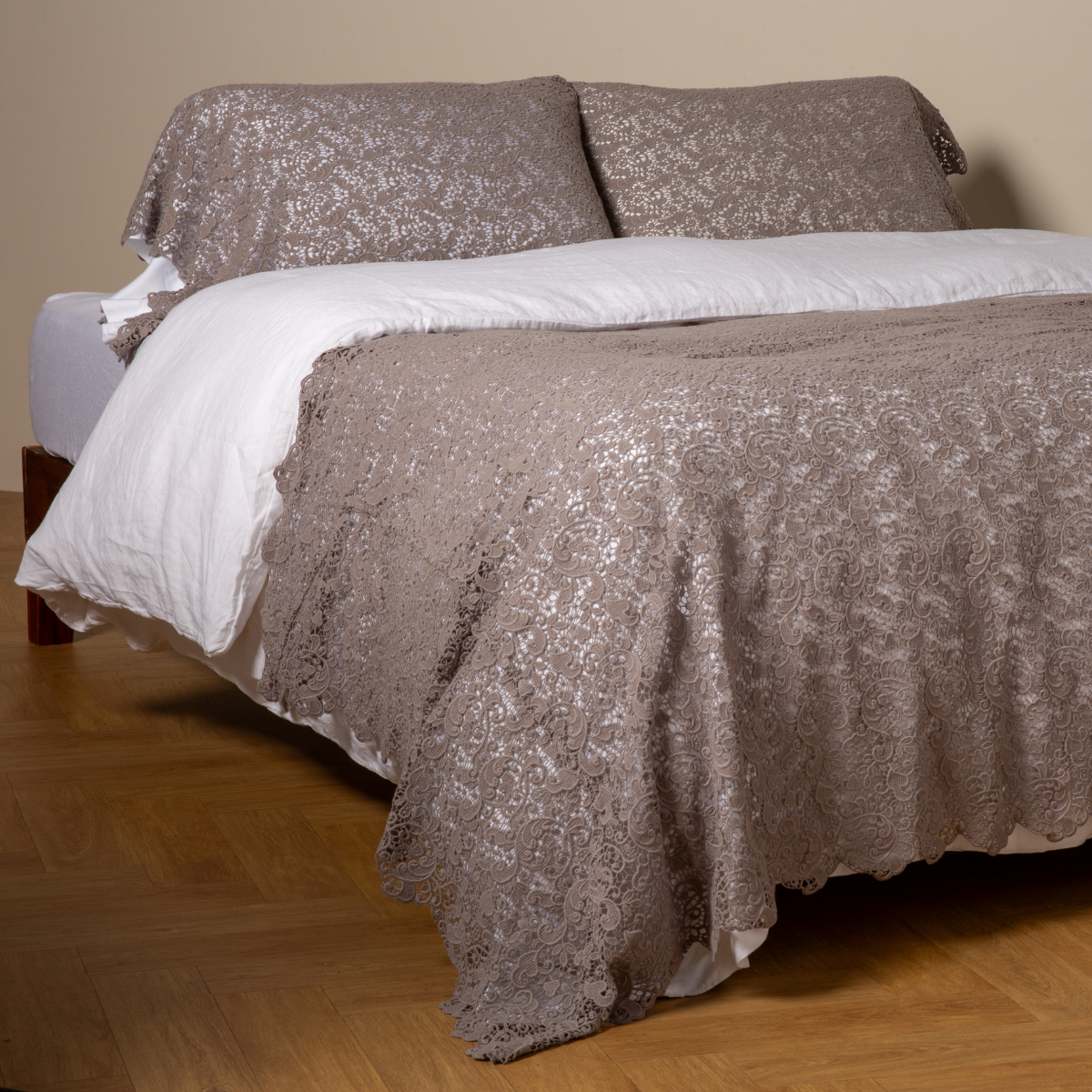 Moonlight: cotton lace bed scarf draped across the foot of a bed dressed in linen sheets and duvet cover in winter white -  shown with matching lace pillowcase covers over a linen liner in winter white. 
