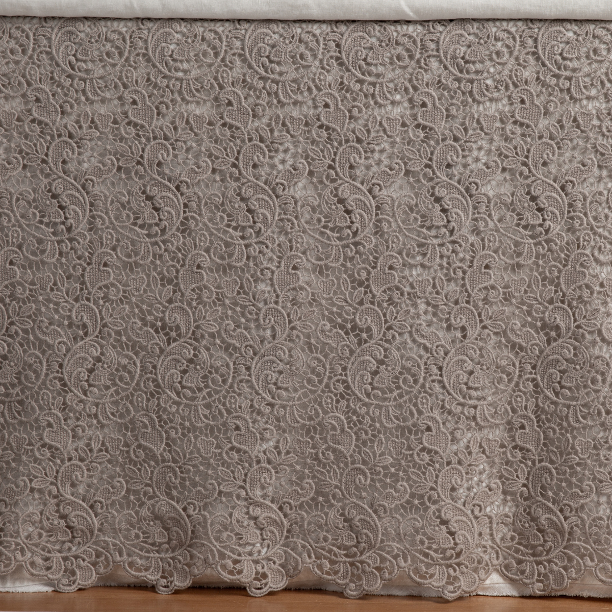 Fog: a close up of a cotton lace bed skirt layered over a winter white bed skirt - shot straight at the bed skirt. 