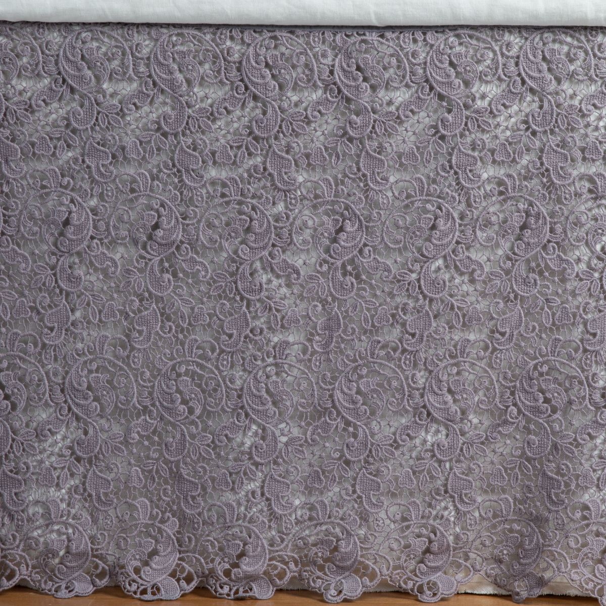 French Lavender: a close up of a cotton lace bed skirt layered over a winter white bed skirt - shot straight at the bed skirt. 