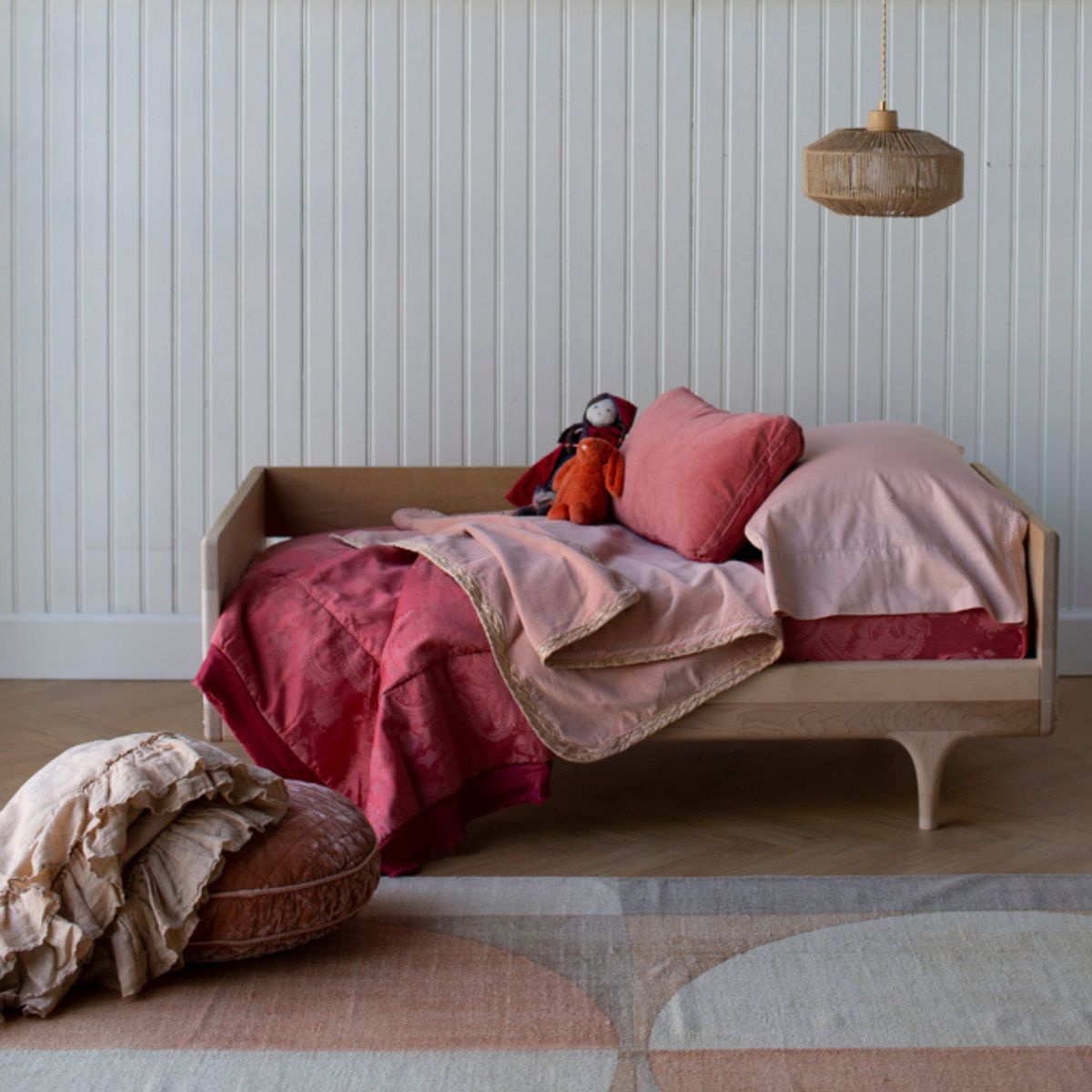 [allvariants]: a feminime toddler bed scene with pink and red bedding and throw pillows. 