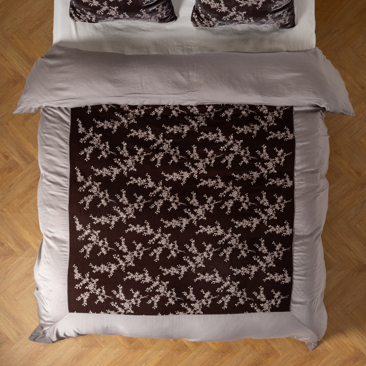 Moonlight: An overhead shot of an embroidered silk velvet and tencel duvet cover and matching shams. 