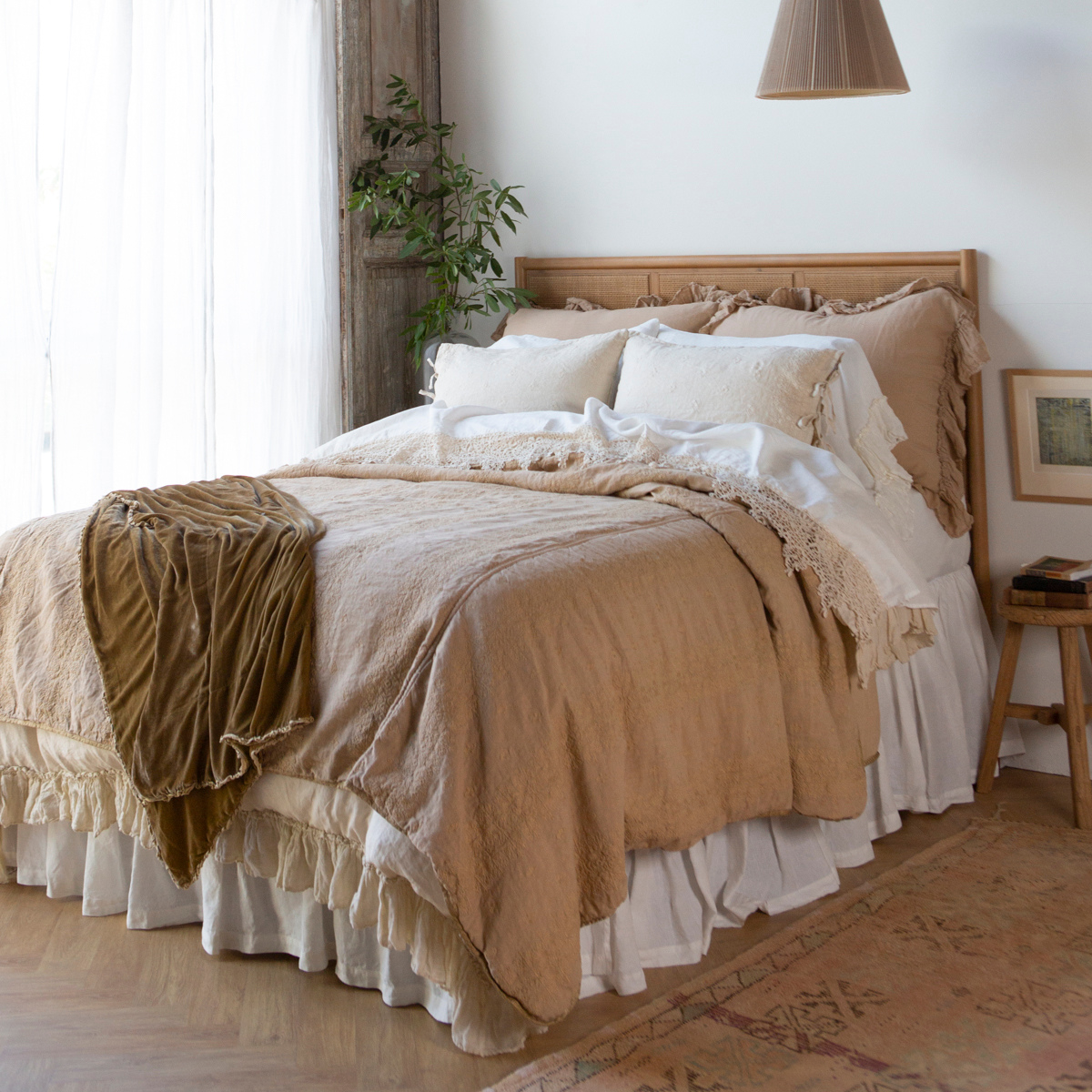 [allvariants]: Bedspread in honeycomb layered under a creamy ruffled duvet - close up angled view.