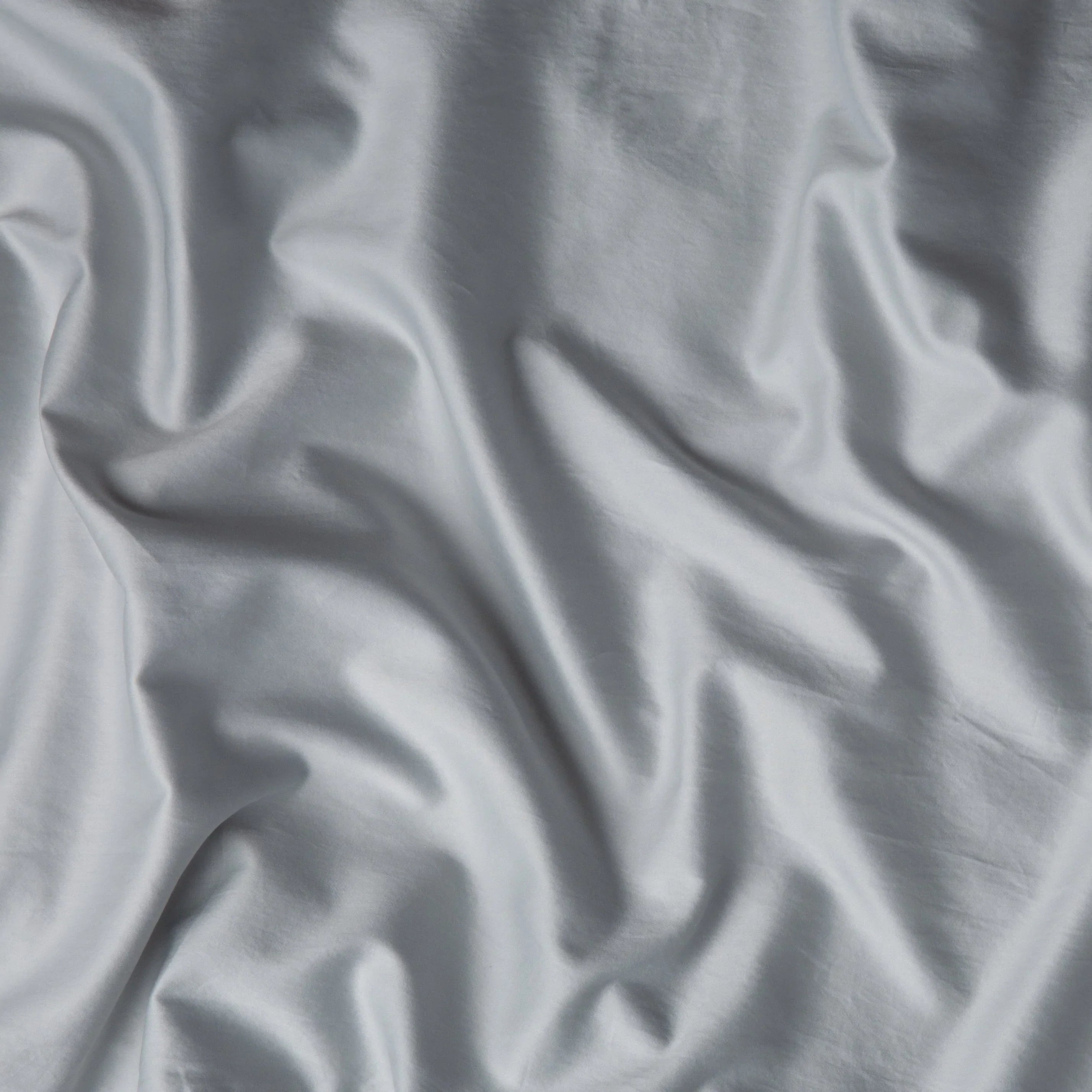 Cloud: A close up of cotton sateen fabric in sterling, a silvery neutral light grey. 