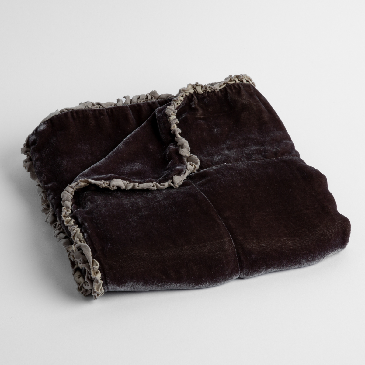 Moonlight:  silk velvet baby blanket with charmeuse trim shown slightly overhead with a corner folded back to show trim detail against a white background. 