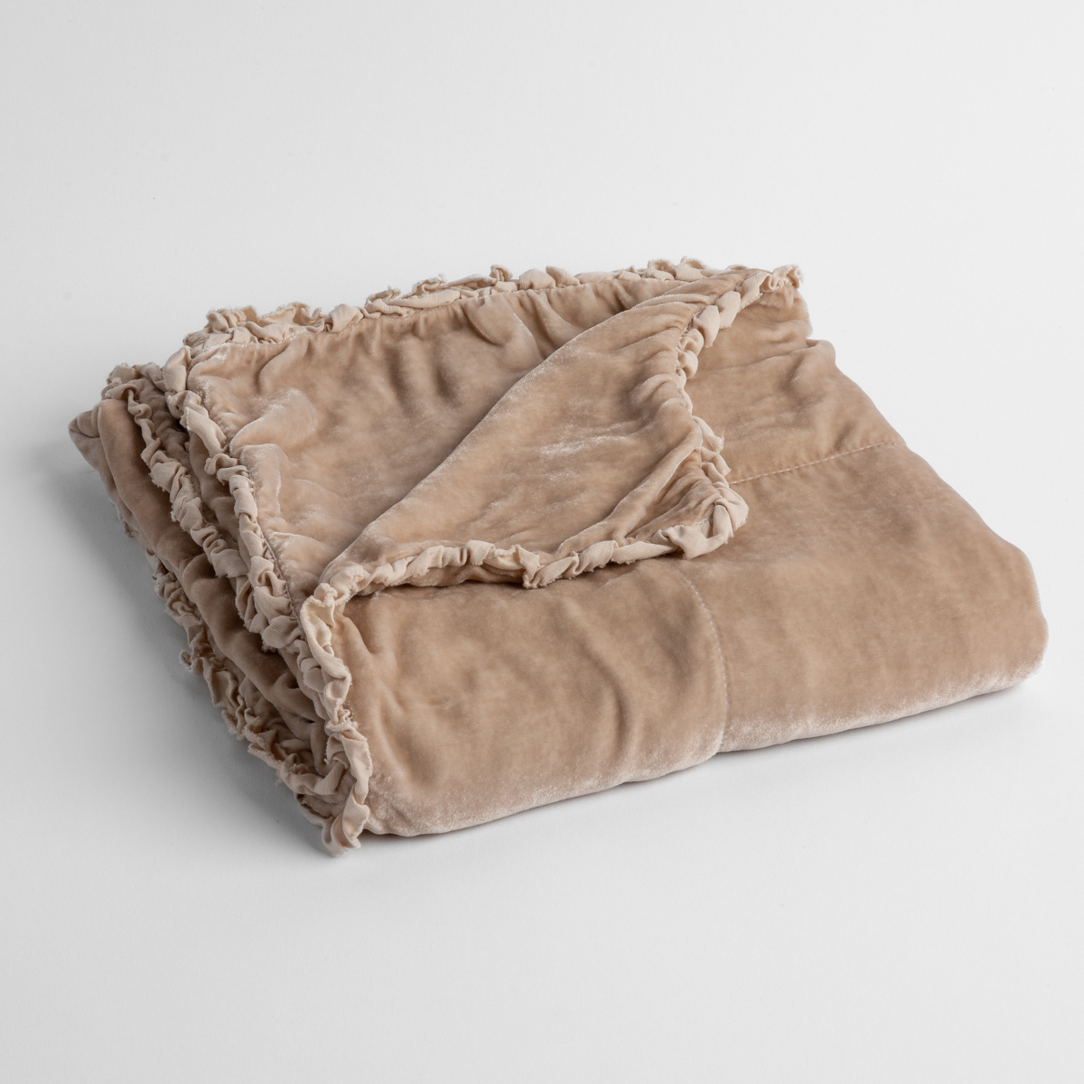 Pearl:  silk velvet baby blanket with charmeuse trim shown slightly overhead with a corner folded back to show trim detail against a white background. 