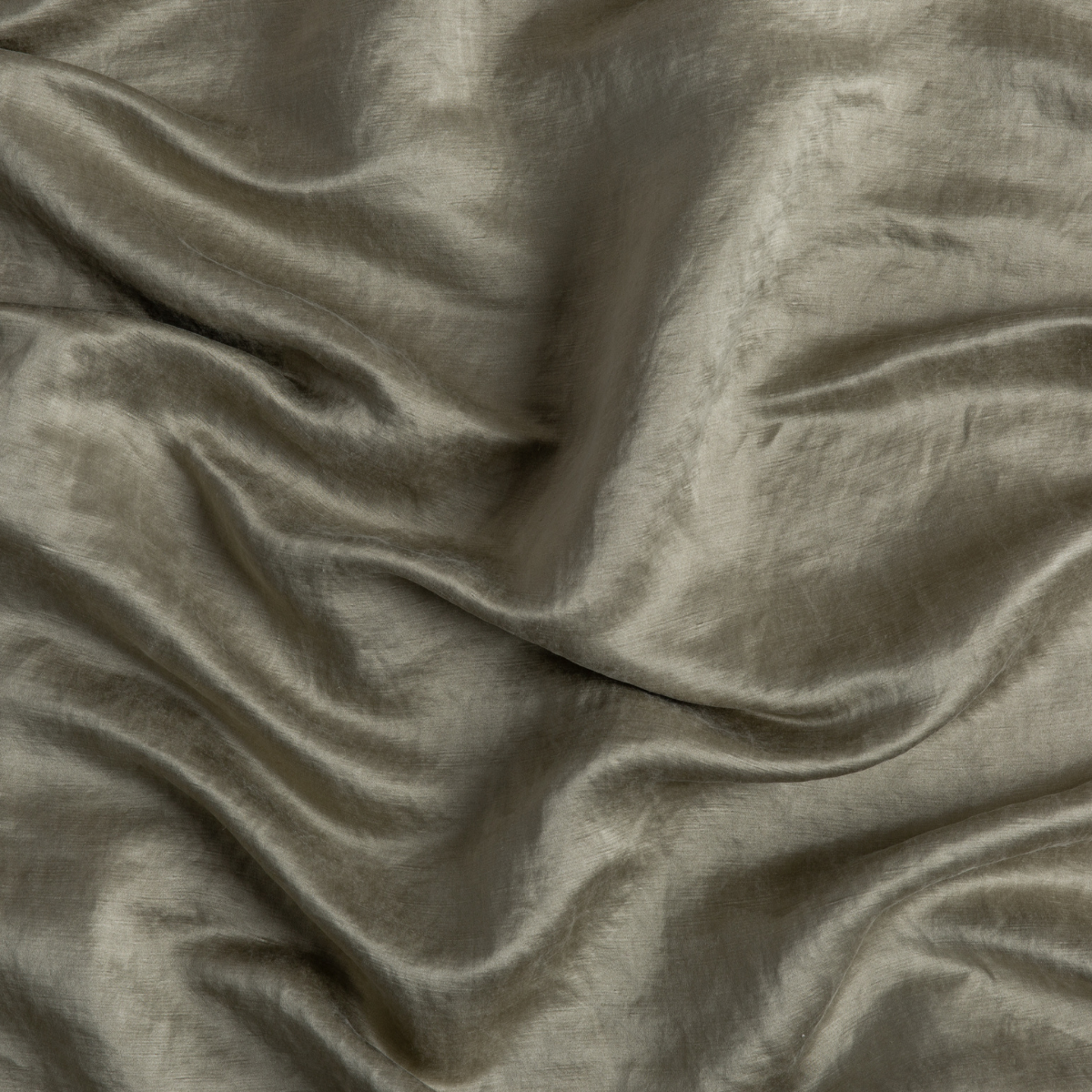 Fog: A close up of charmeuse fabric in fog, a neutral-warm, soft mid-tone grey.