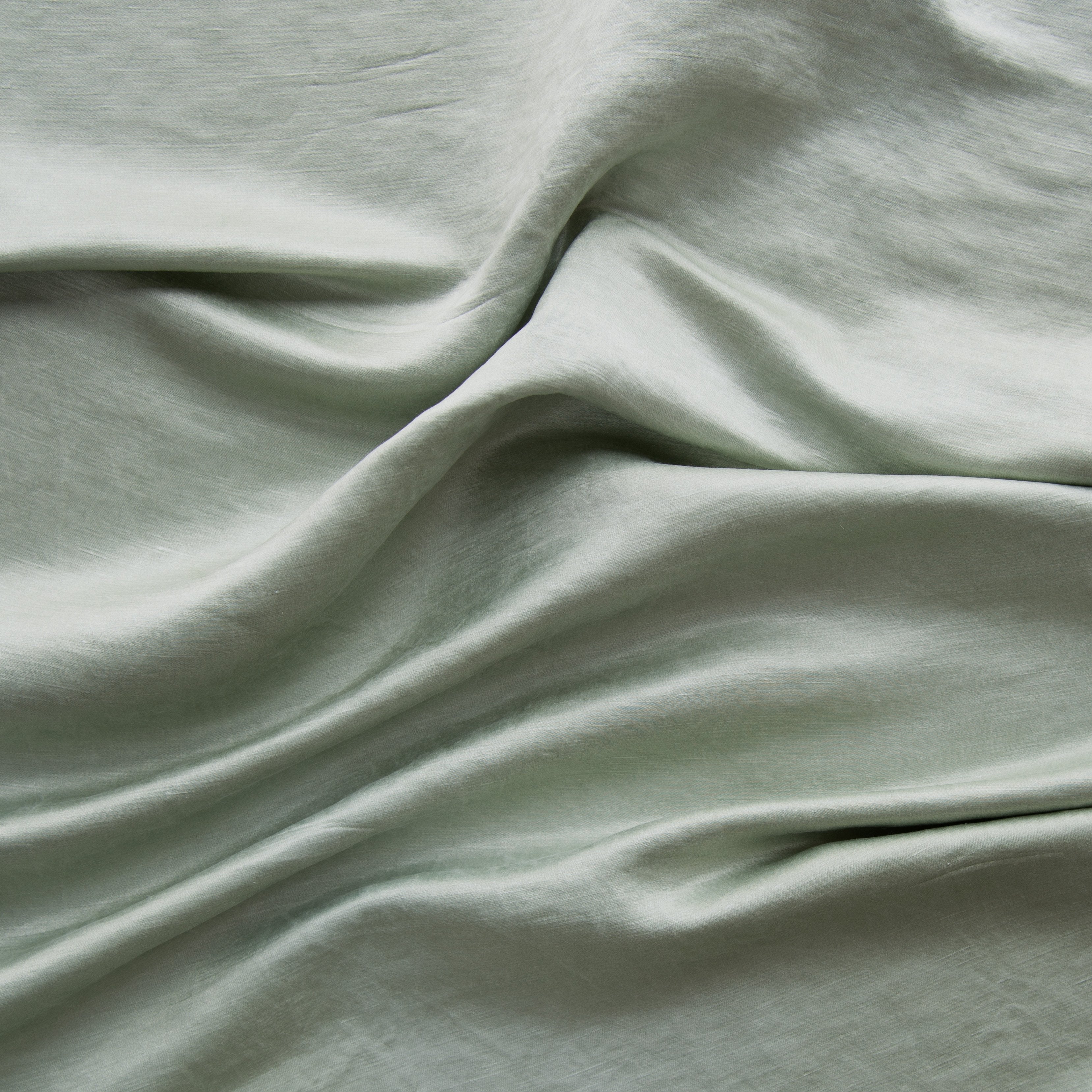Eucalyptus: Close-up of silk charmeuse in eucalyptus, a soft, light green. 