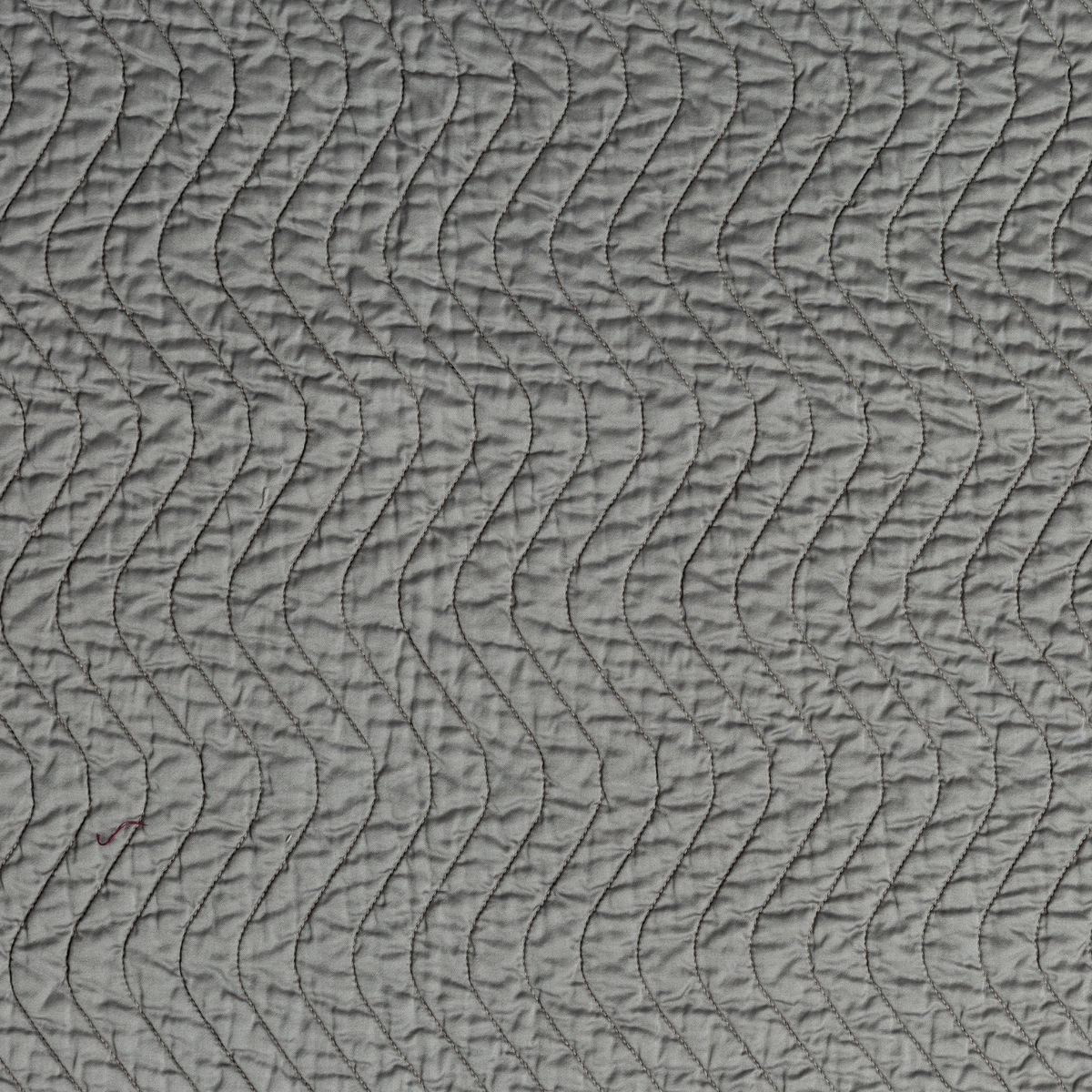 Moonlight: A close up of quilted cotton sateen fabric in moonlight, a saturated, cool, mid-dark grey tone.