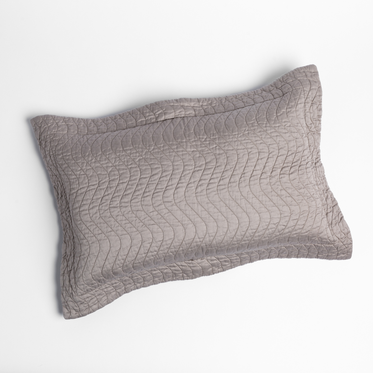 Fog: 15x24 quilted cotton sateen throw pillow shot overhead against a white background.