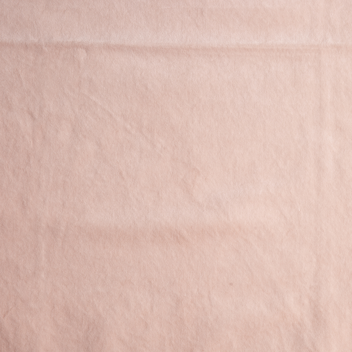 Pearl: A close up of cotton velvet fabric in pearl, a nude-like, soft rose pink tone.