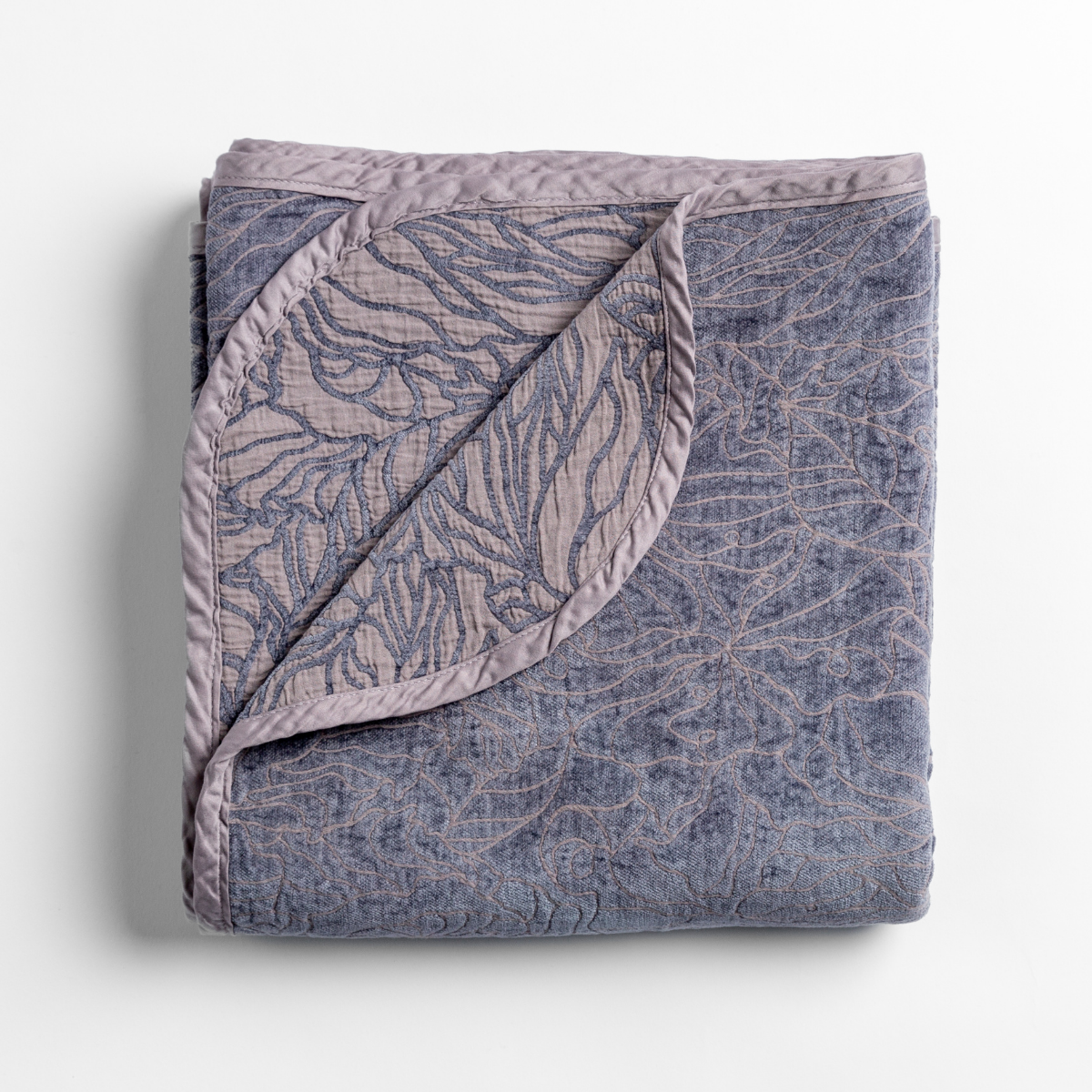French Lavender: folded blanket with its cotton jacquard side visible on the corner foldback against the chenille jacquard side. 