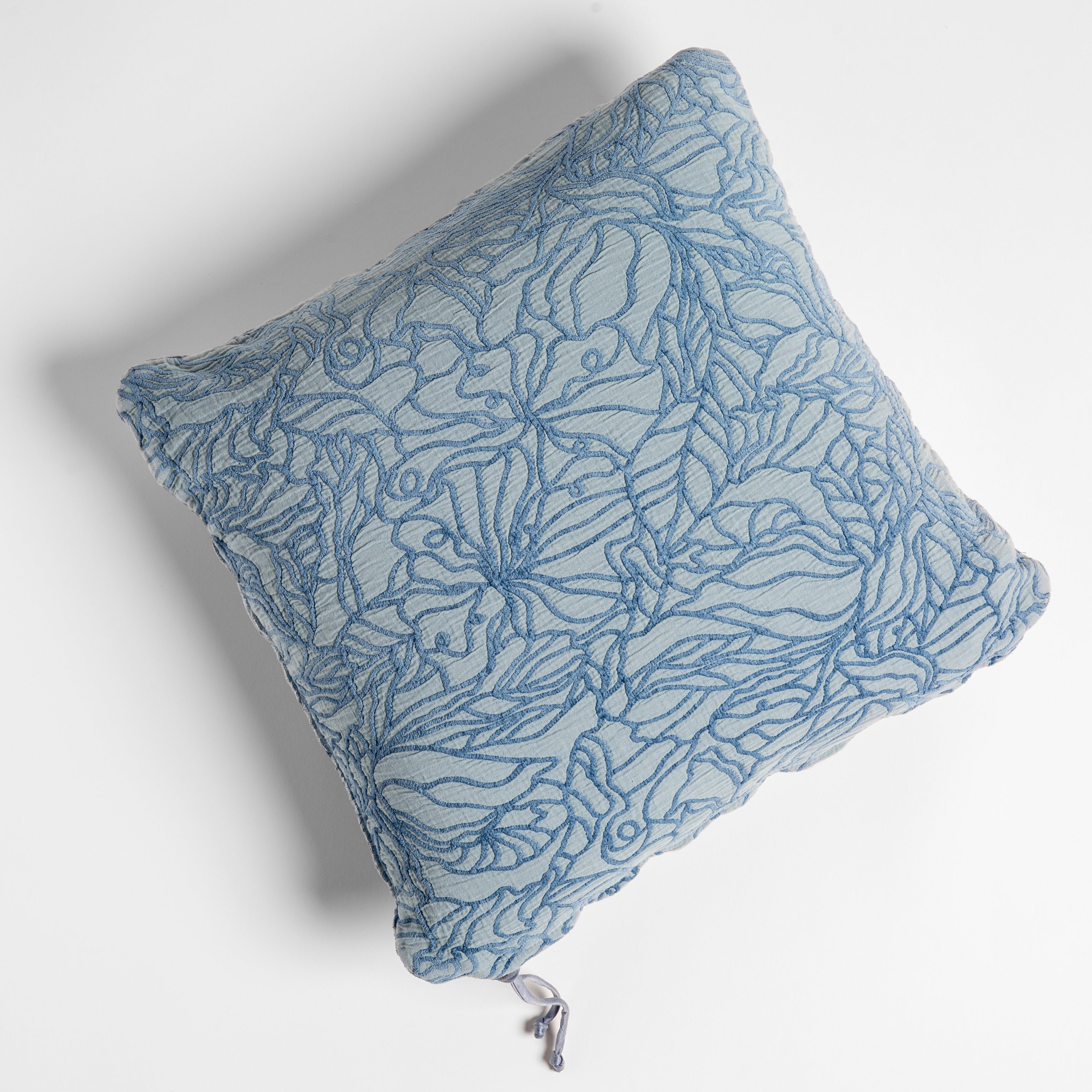Tahoe Blue: cotton jacquard side of a georgia square cushion shown from overhead against a white background. 