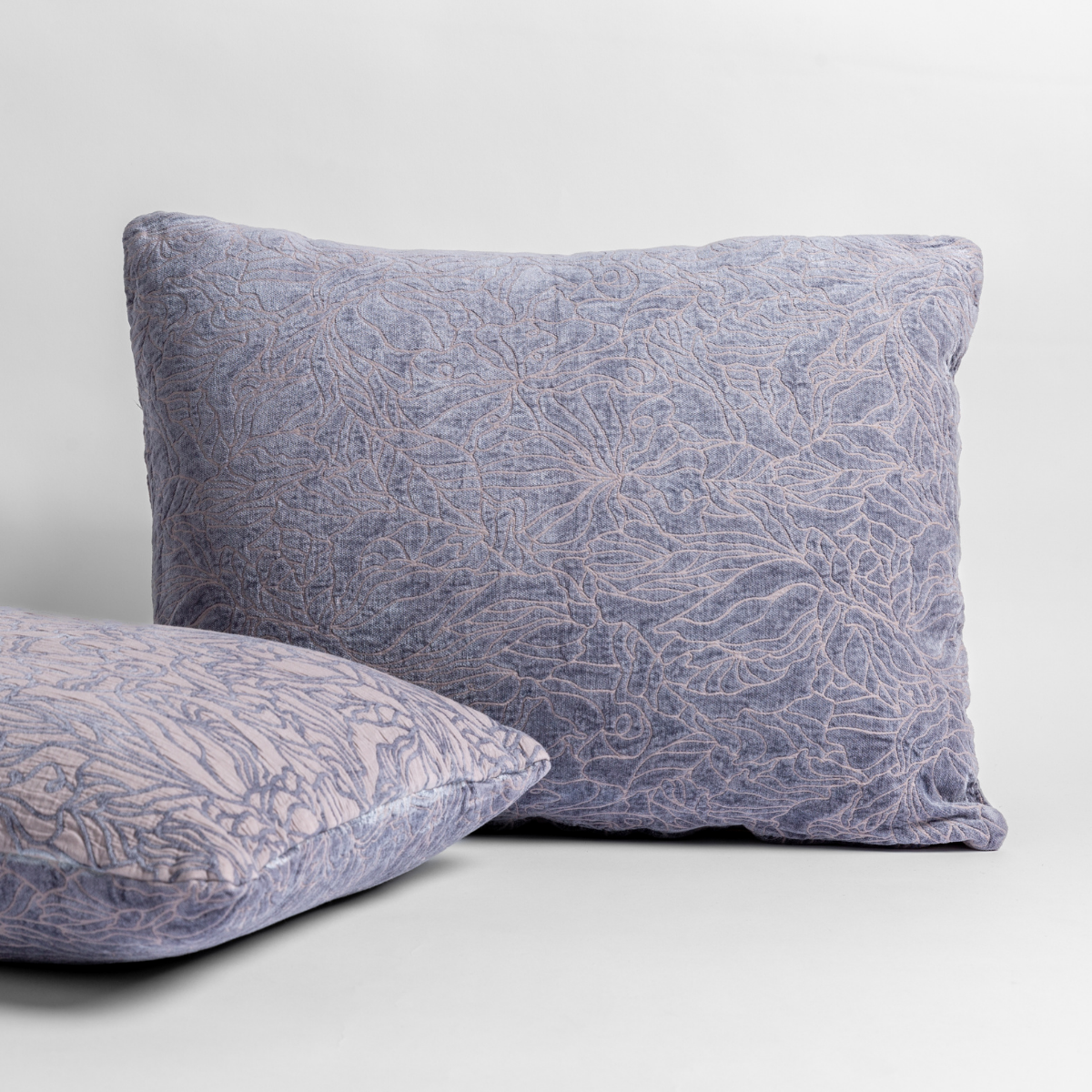 French Lavender: pair of shams shown against a white background show the chenille and cotton jacquard faces and floral motif. 
