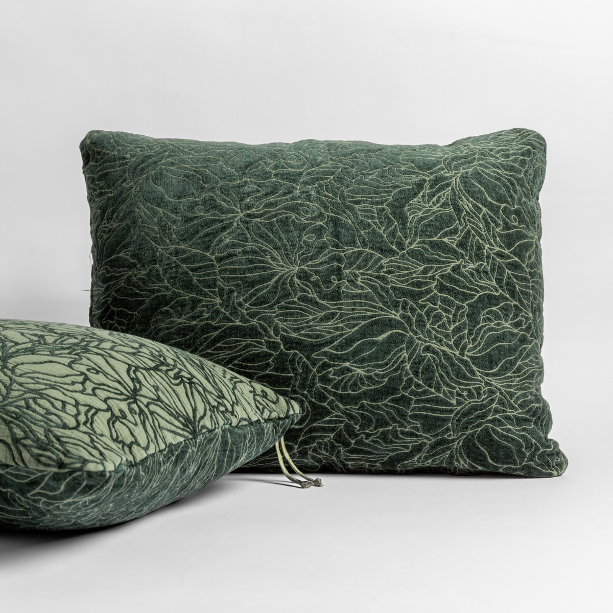 Juniper: pair of shams shown against a white background show the chenille and cotton jacquard faces and floral motif. 