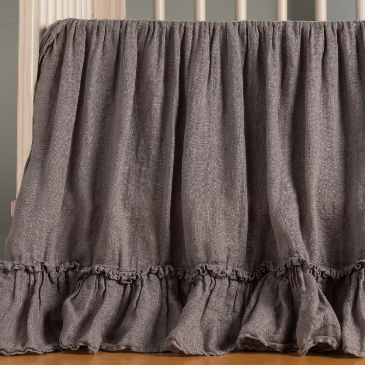 French Lavender: ruffled crib skirt shown on a crib with no mattress. 