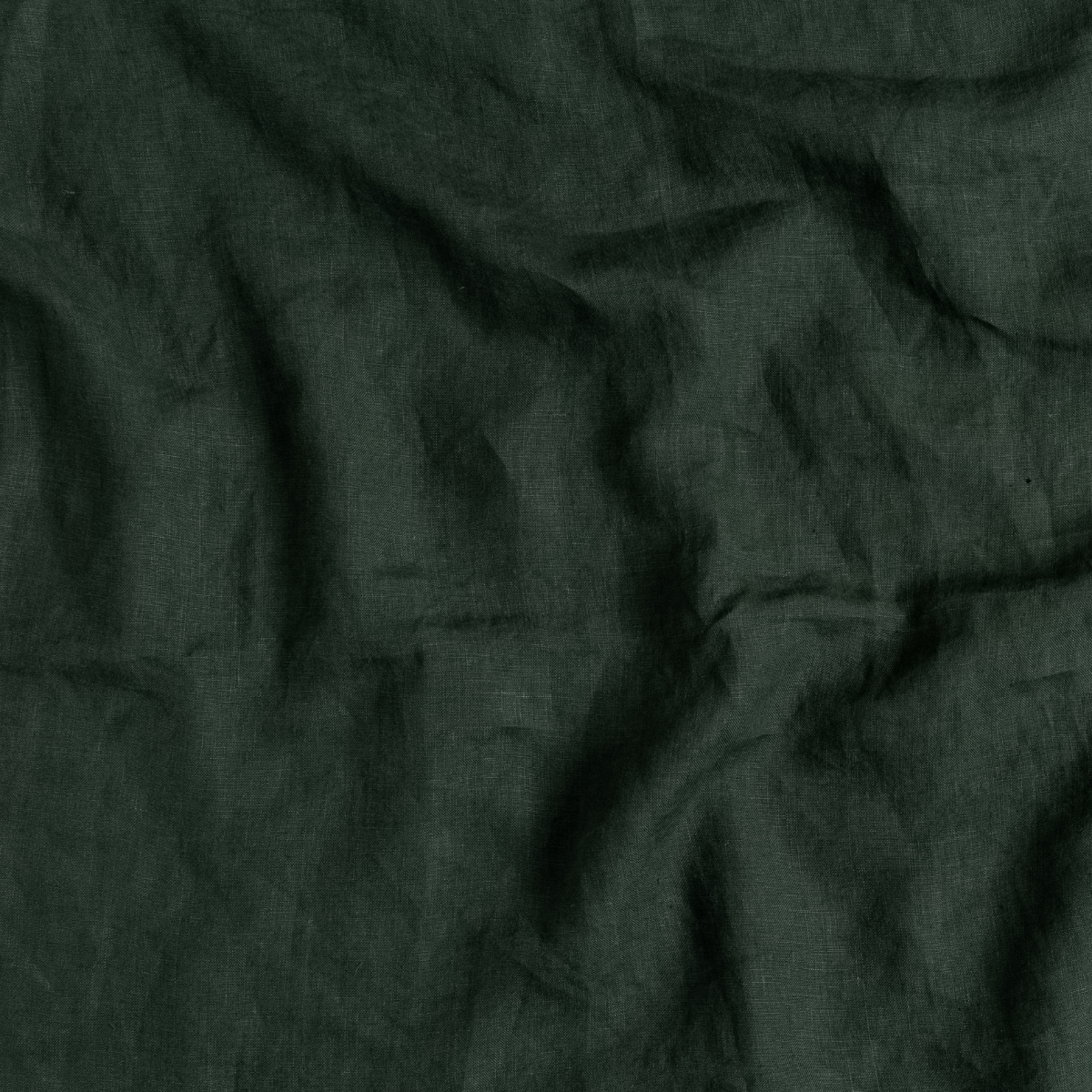 Juniper: A close up of linen fabric in Juniper, a deep green tone.
