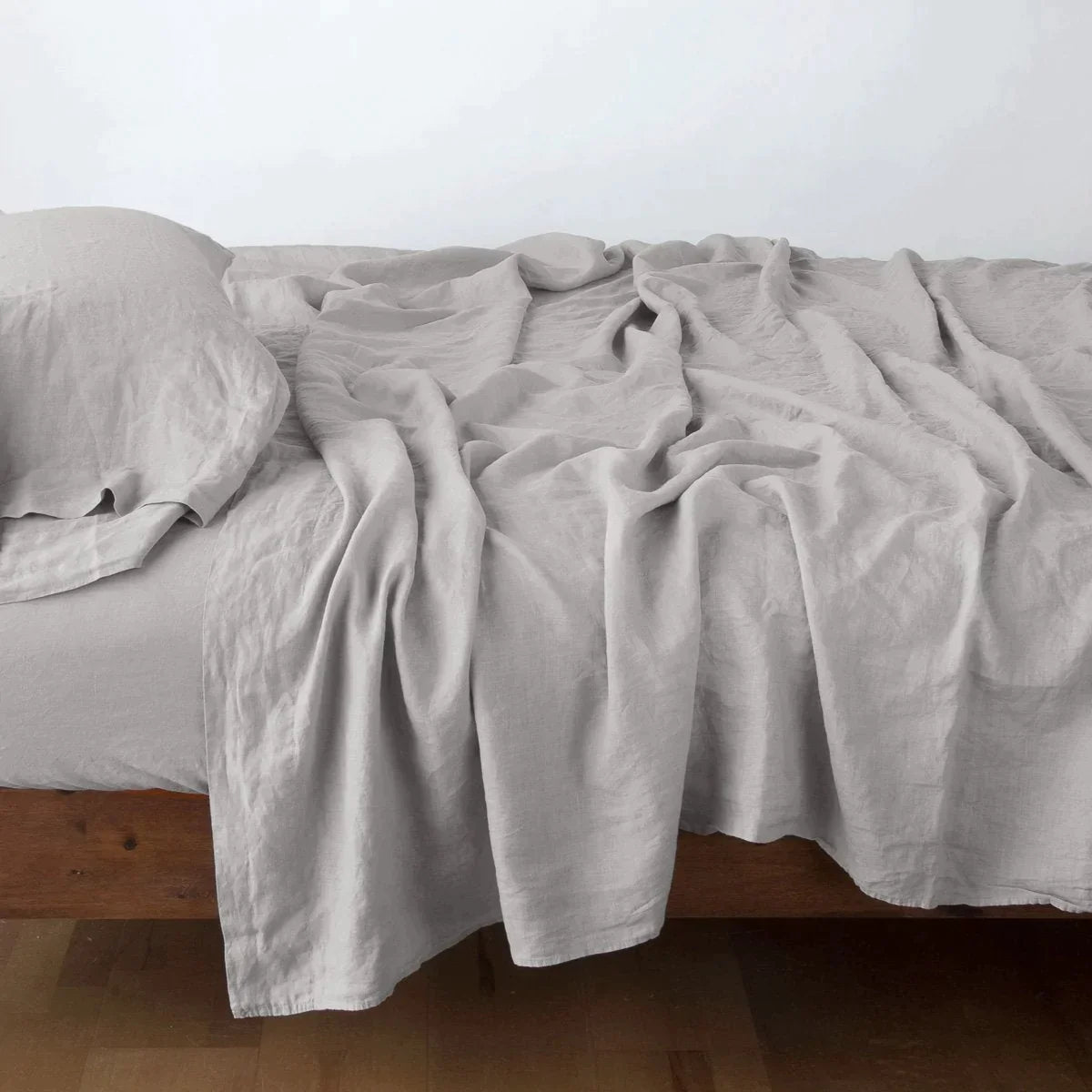 Fog: Rumpled linen sheeting with matching sleeping pillow - side view.
