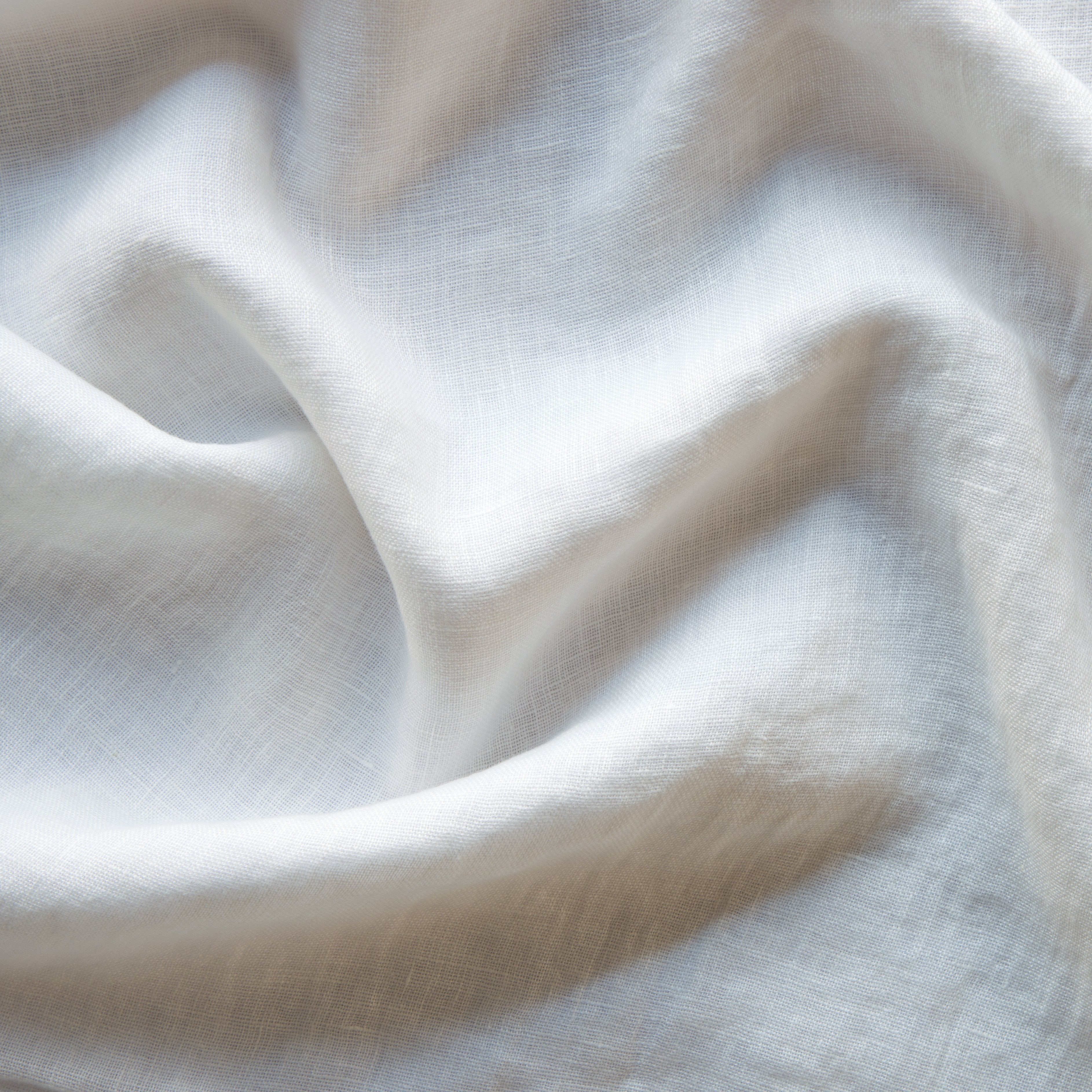 White: A close up of linen whisper, our lightweight linen gauze, in white.