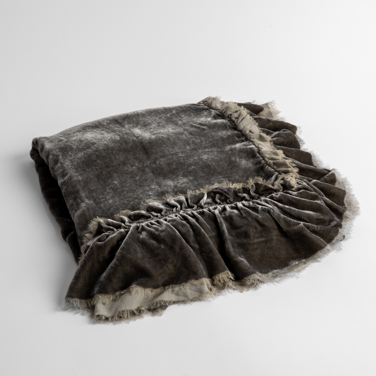 Fog:  an overhead shot of a folded silk velvet baby blanket with a raw-edged eyelash ruffle detail.