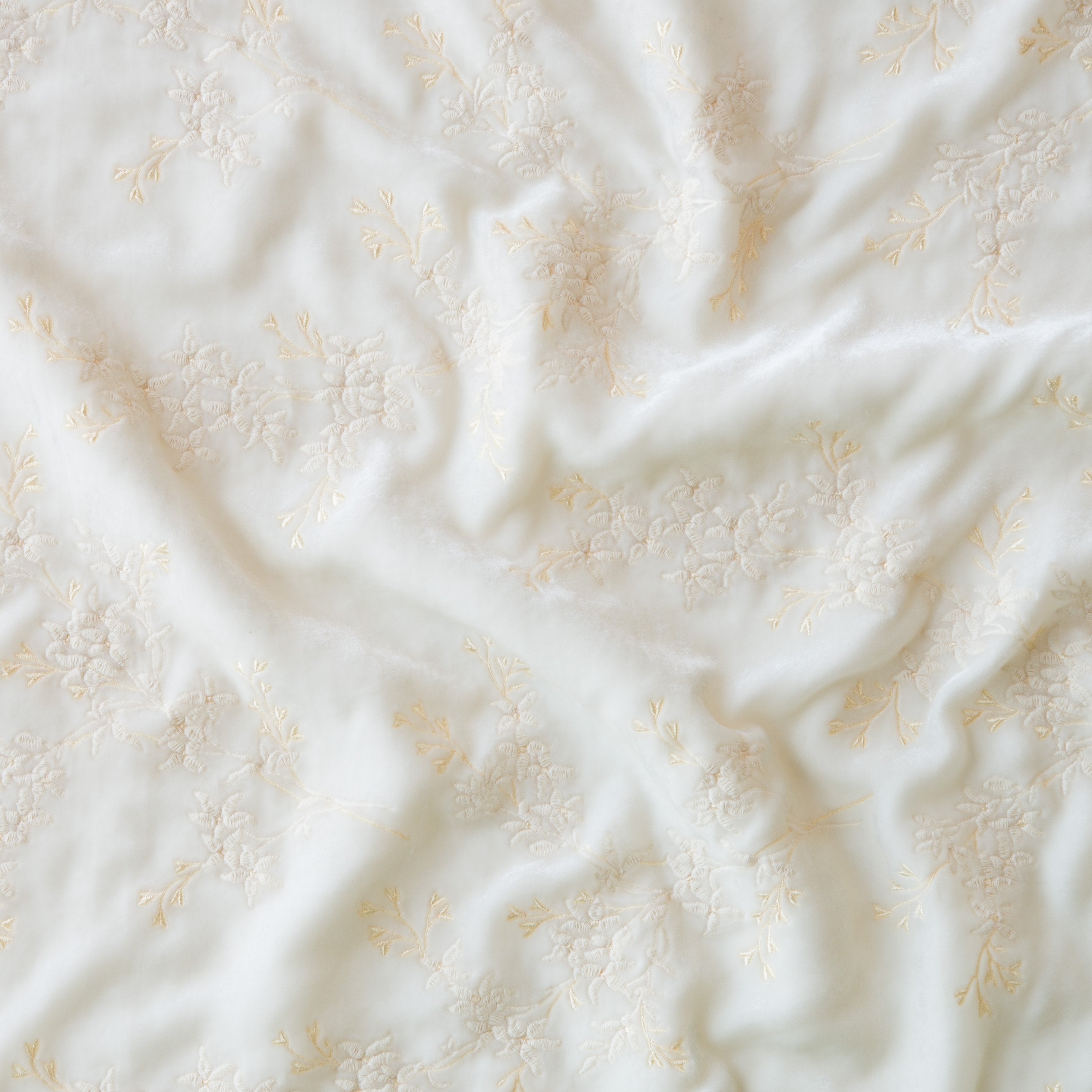 Winter White: A close up of Ines, Lynette embroidered silk velvet, in winter white, softer and warmer in tone than classic white.