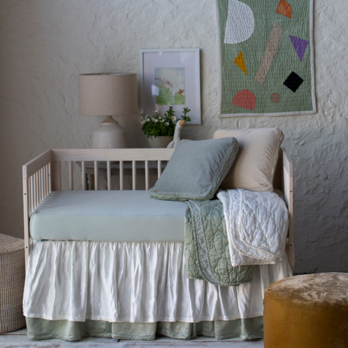 [allvariants]: Crib sheet in eucalyptus shown in a soft green and cream toned nursery with varied textures.