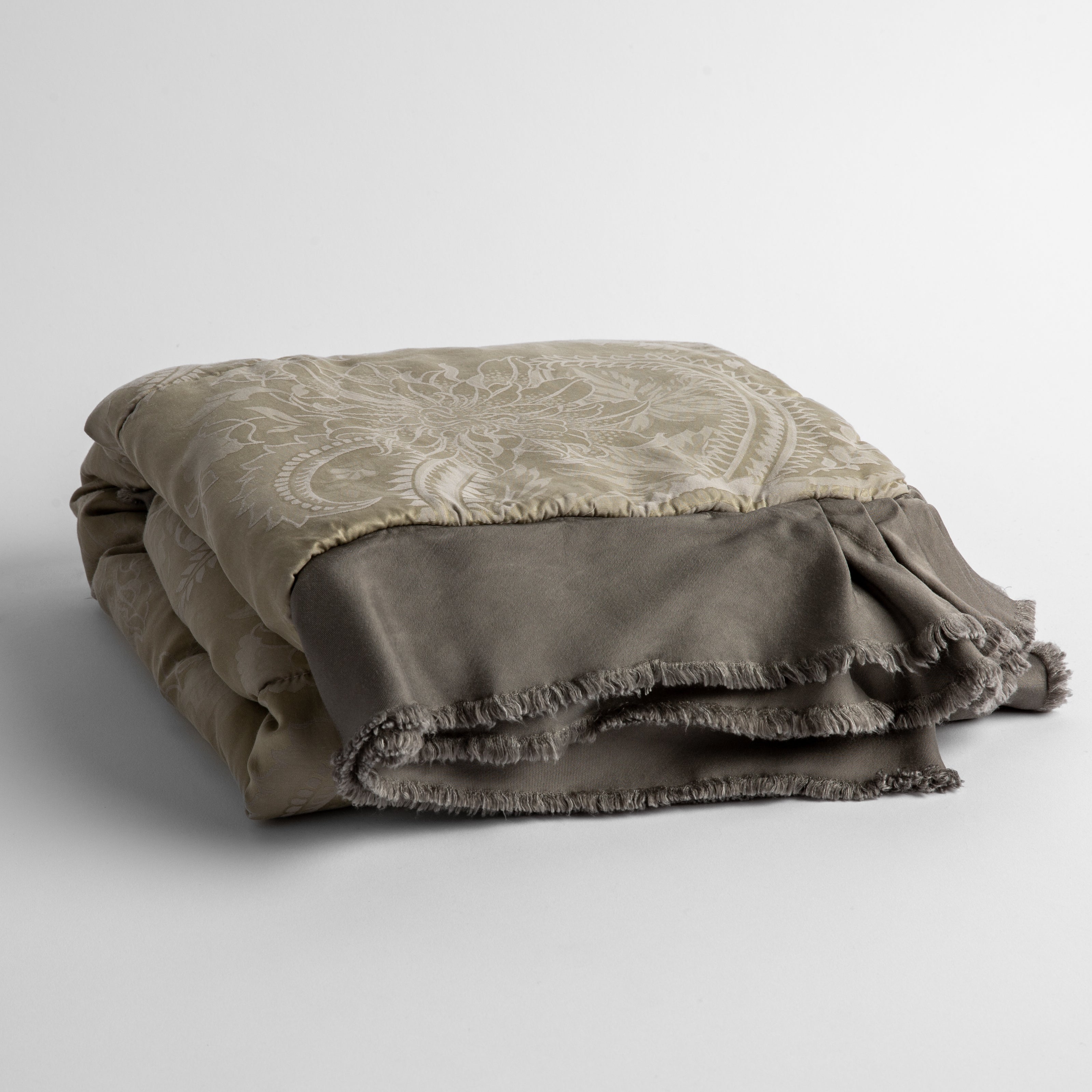 Fog: a silk and tencel™ jacquard baby blanket folded and shot against a white background with the ruffled trim situated to be visible
