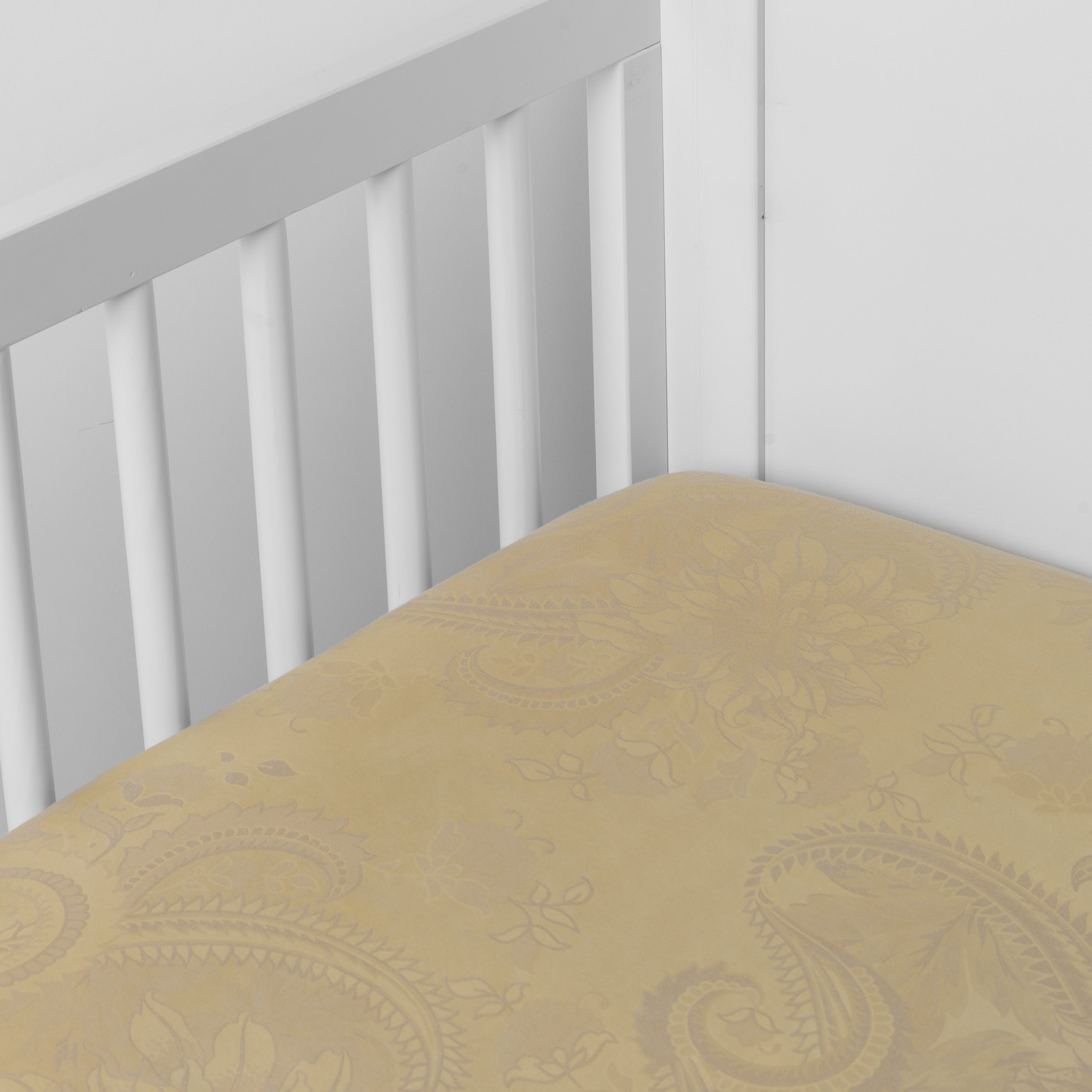 Honeycomb: a silk and tencel™ crib sheet shown slightly overhread and shot into the corner of a white crib. 
