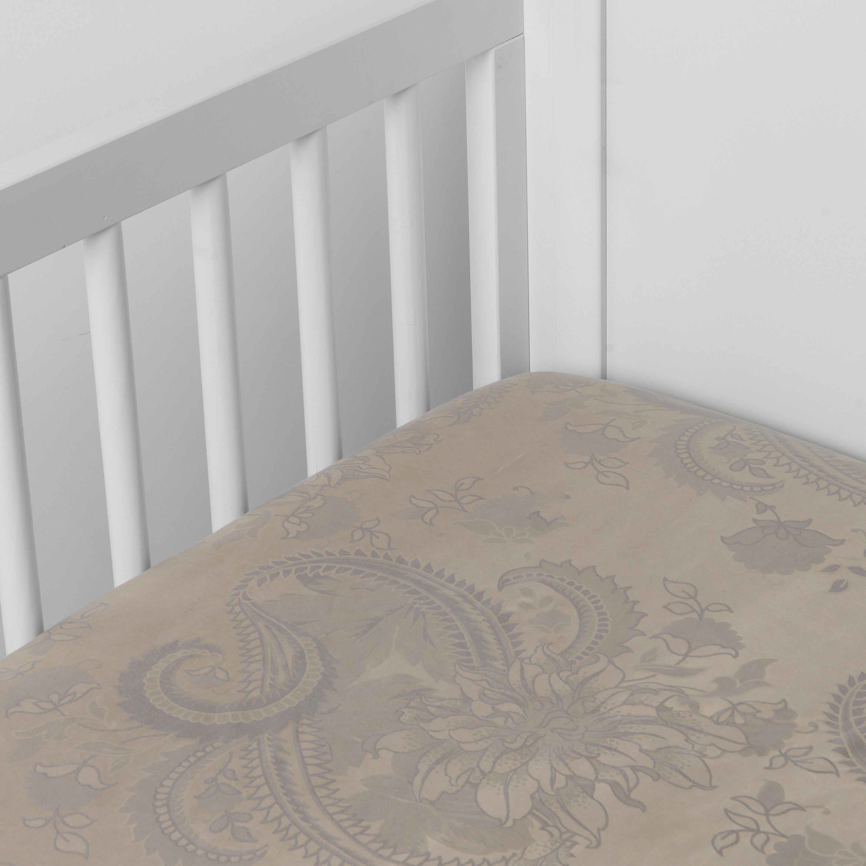 Moonlight: a silk and tencel™ crib sheet shown slightly overhread and shot into the corner of a white crib. 