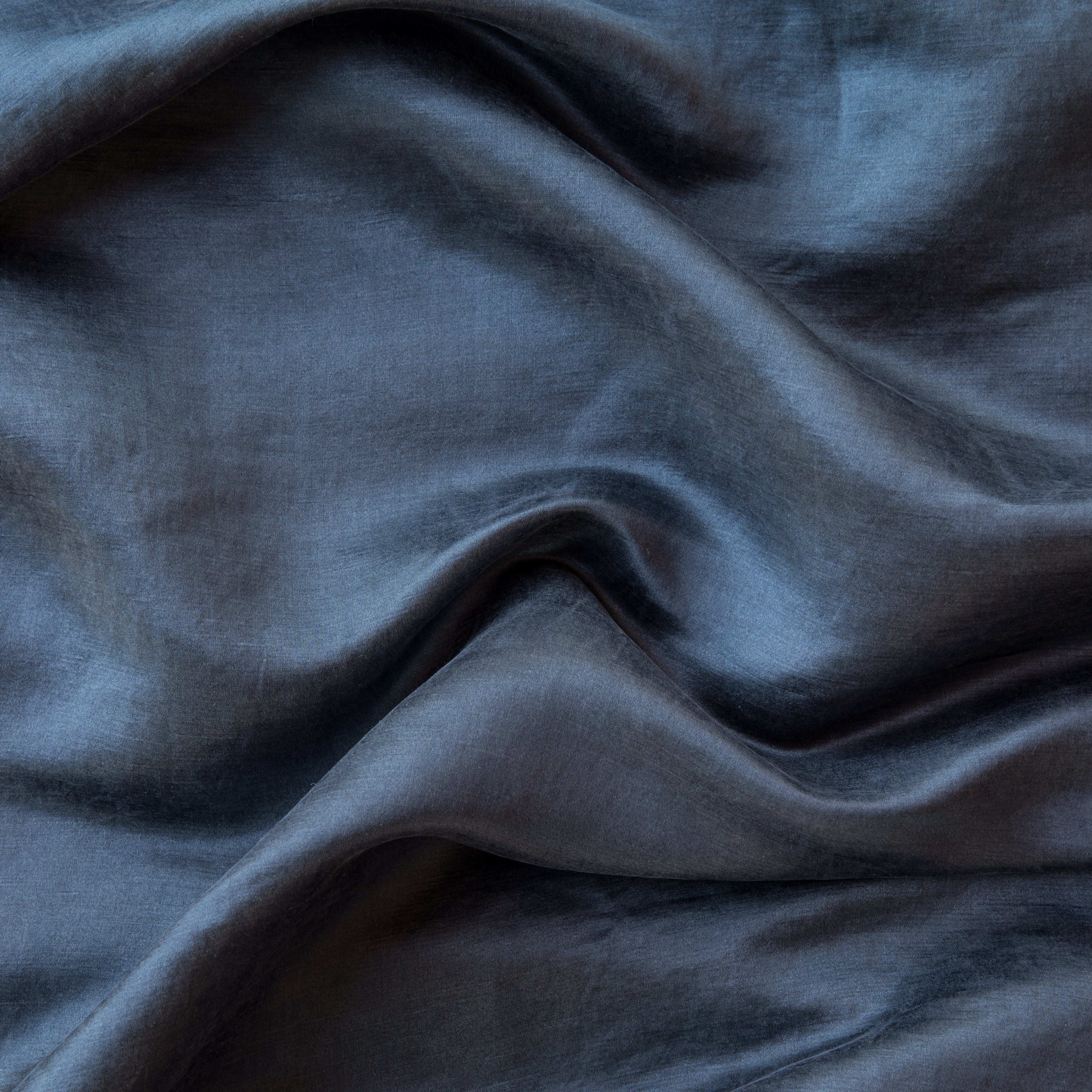 Midnight: Close-up of silk charmeuse in midnight, a rich indigo tone. 