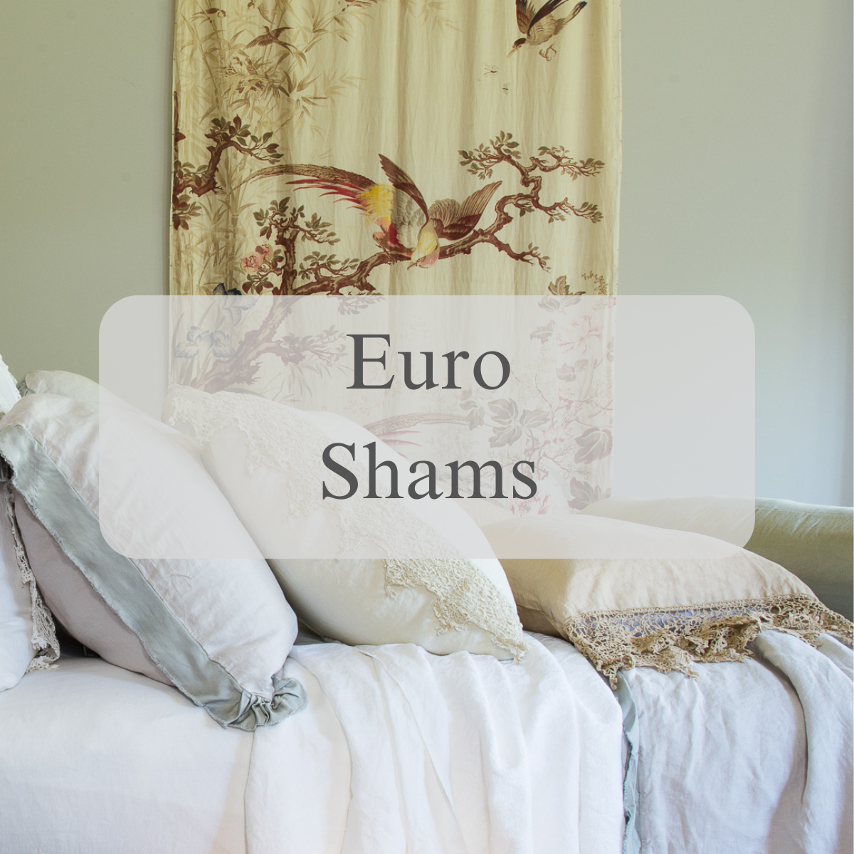 Shams in light tones stacked against each other on a bed shown from the side view with a text overlay that reads "Euro Shams"